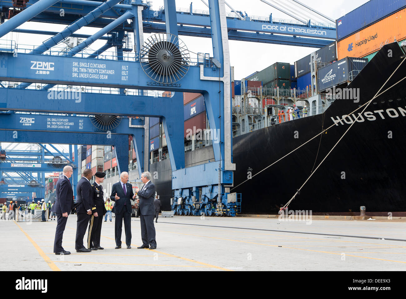 US Vice President Joe Biden speaks with Charleston Ports Authority CEO Jim Newsome, right, General Jackson and Transportation Secretary Anthony Foxx during a visit to Wando Welch Terminal on September 16, 2013 in Charleston, South Carolina. Biden spoke about the need to improve America's transportation infrastructure for exports and economic growth. Stock Photo