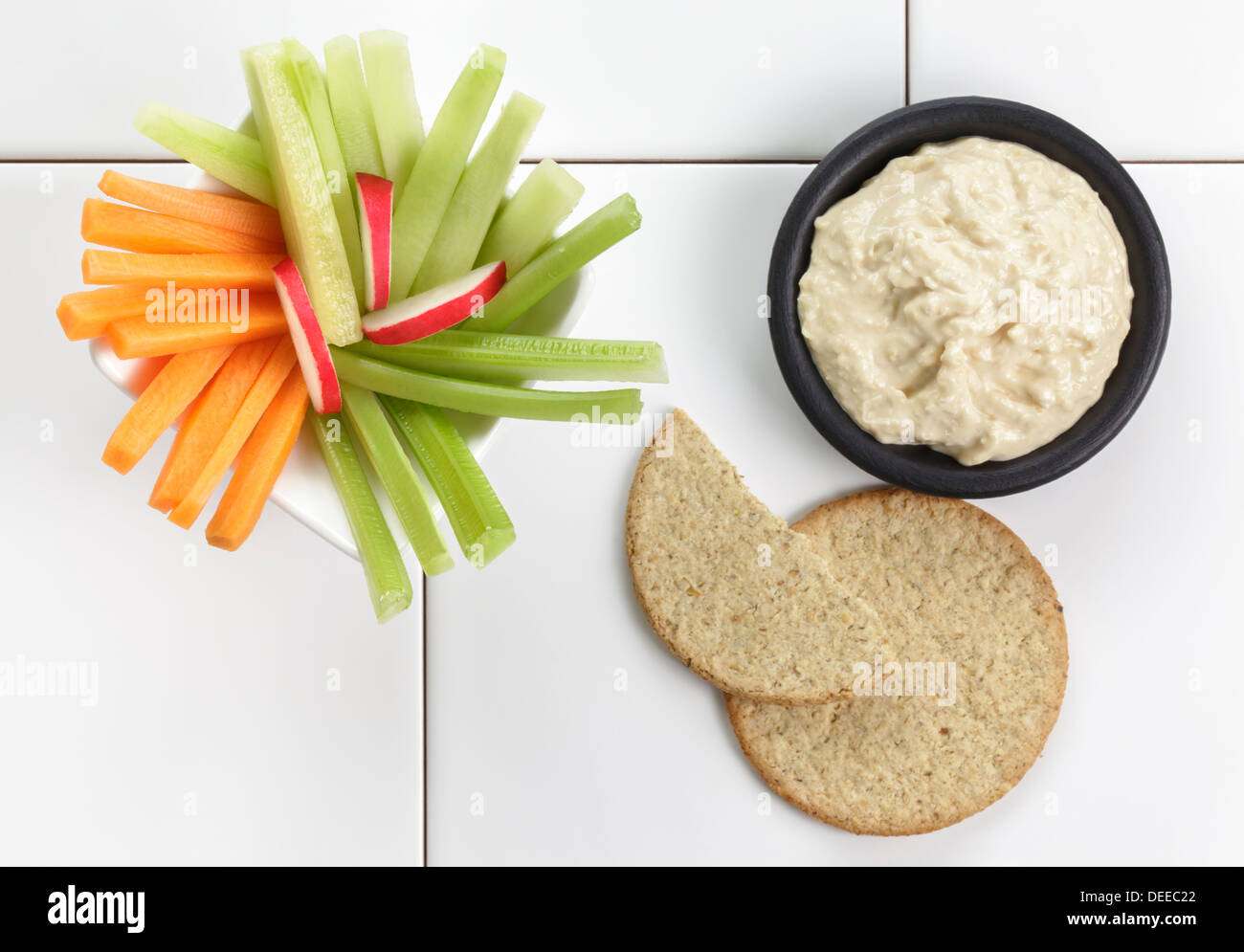 Houmous or Hummus with fresh vegetables and oatcakes Stock Photo