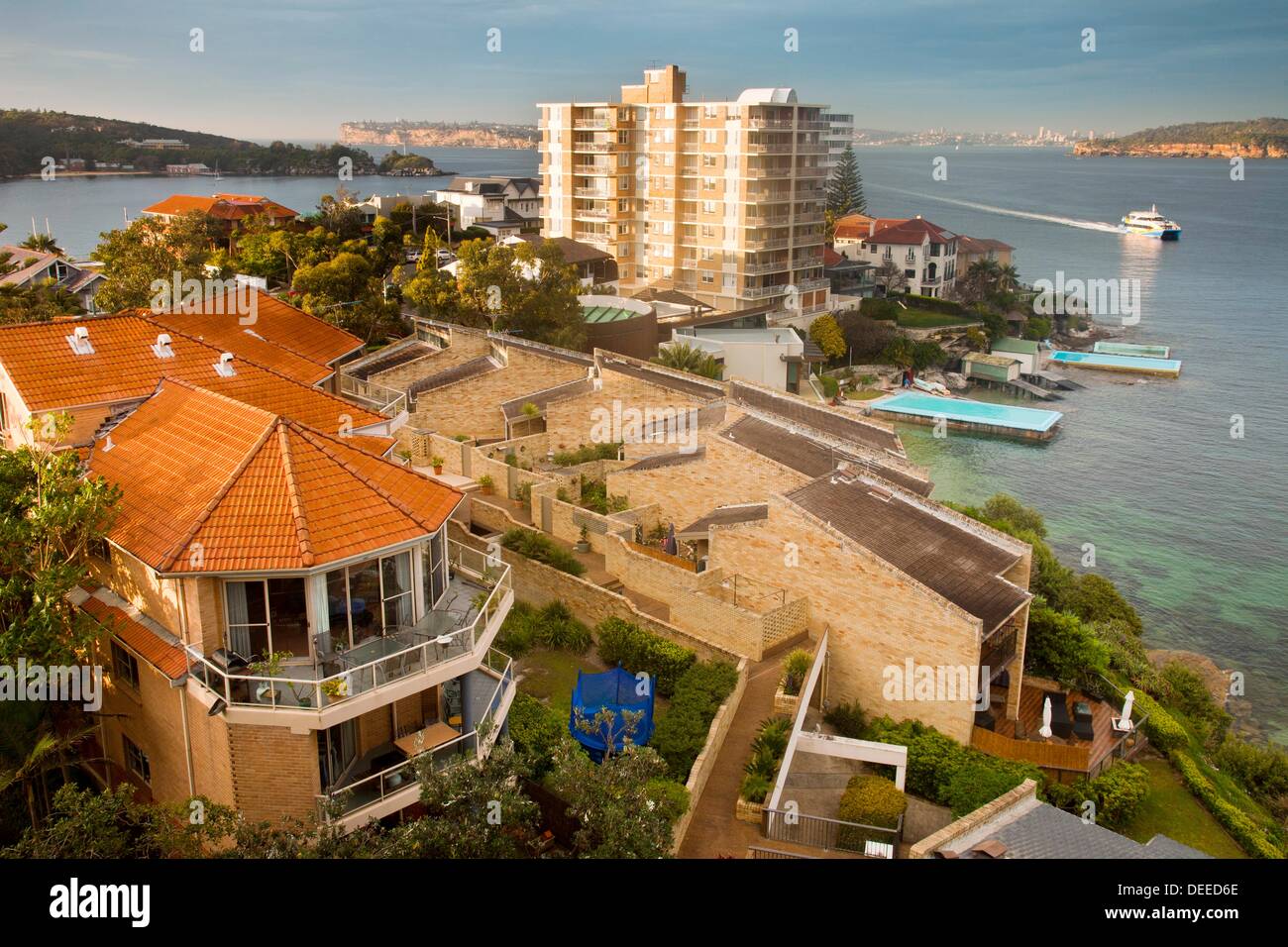Ferry arrives Manly wharf, typical Manly waterfront homes and units