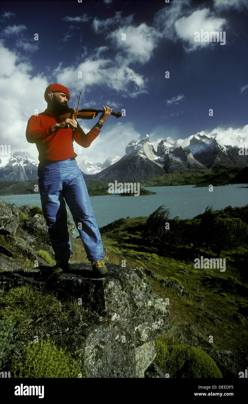 Fiddle player beside Lago Pehoe with view to Cuernos del Paine Torres del Paine National Park Patagonia Chile Stock Photo