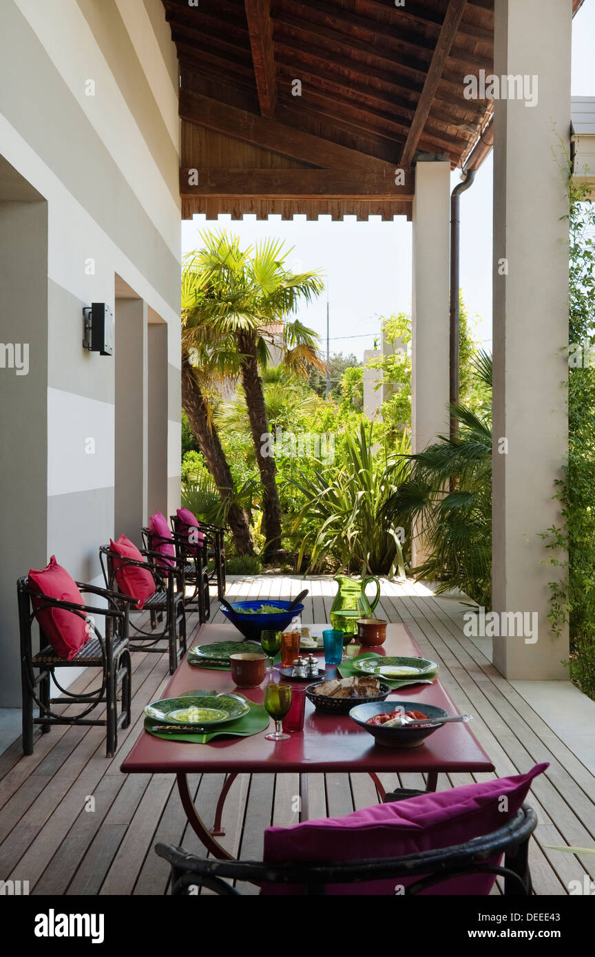 Seating and table on outside terrace in the home of Bruno and Dominique Lafourcade in Provence Stock Photo
