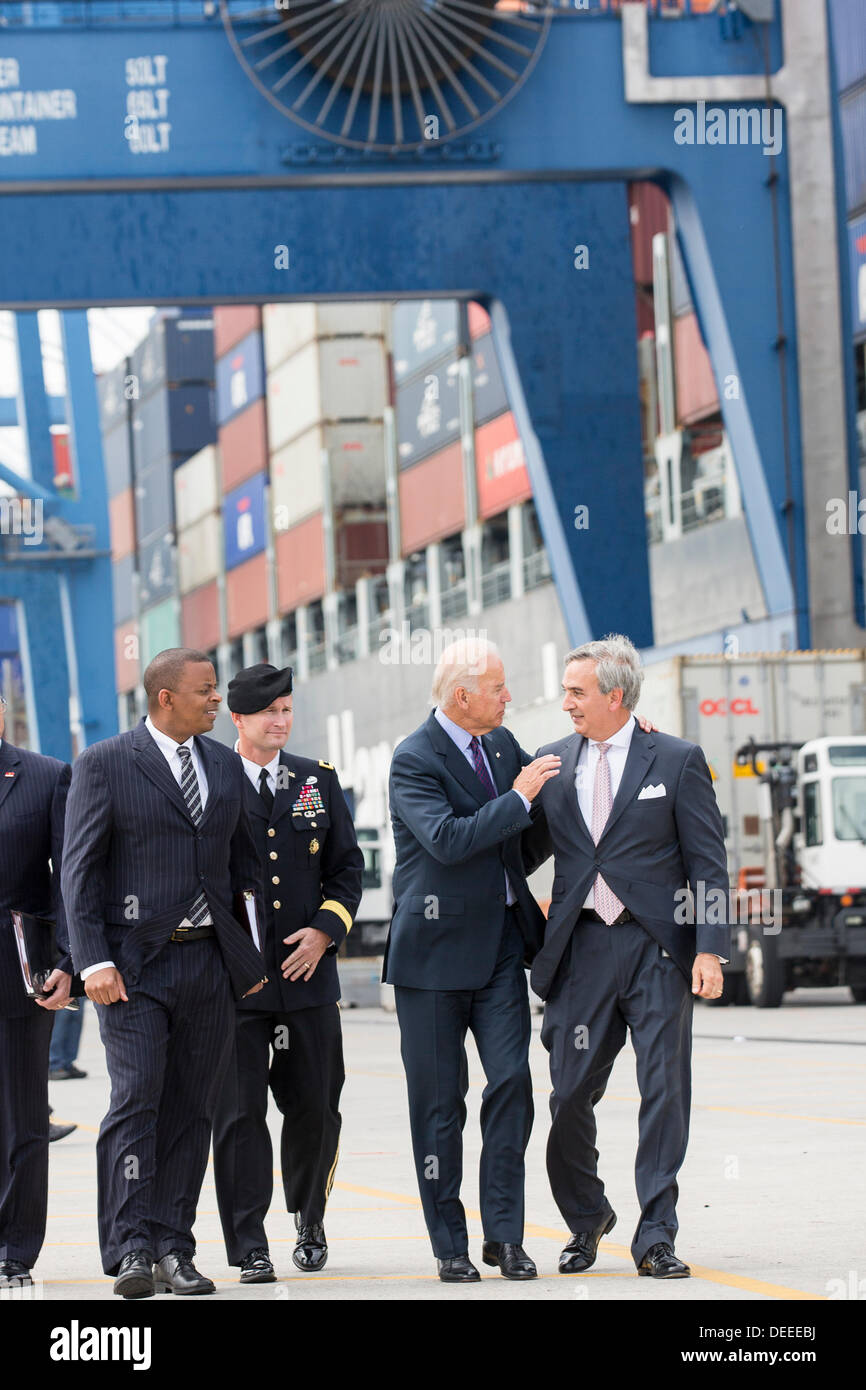 US Vice President Joe Biden walks with Charleston Ports Authority CEO Jim Newsome, right, General Jackson and Transportation Secretary Anthony Foxx during a visit to Wando Welch Terminal on September 16, 2013 in Charleston, South Carolina. Biden spoke about the need to improve America's transportation infrastructures for exports and economic growth. Stock Photo