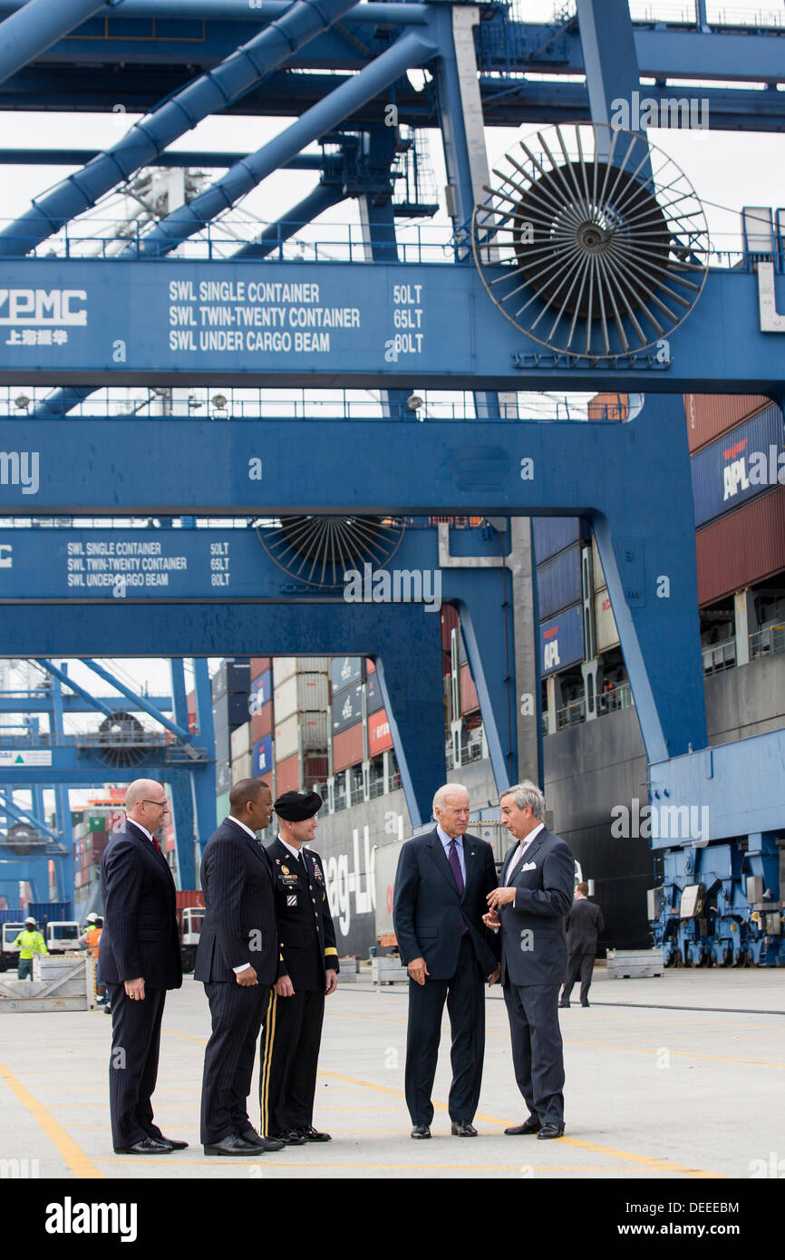 US Vice President Joe Biden walks with Charleston Ports Authority CEO Jim Newsome, right, General Jackson and Transportation Secretary Anthony Foxx during a visit to Wando Welch Terminal on September 16, 2013 in Charleston, South Carolina. Biden spoke about the need to improve America's transportation infrastructures for exports and economic growth. Stock Photo