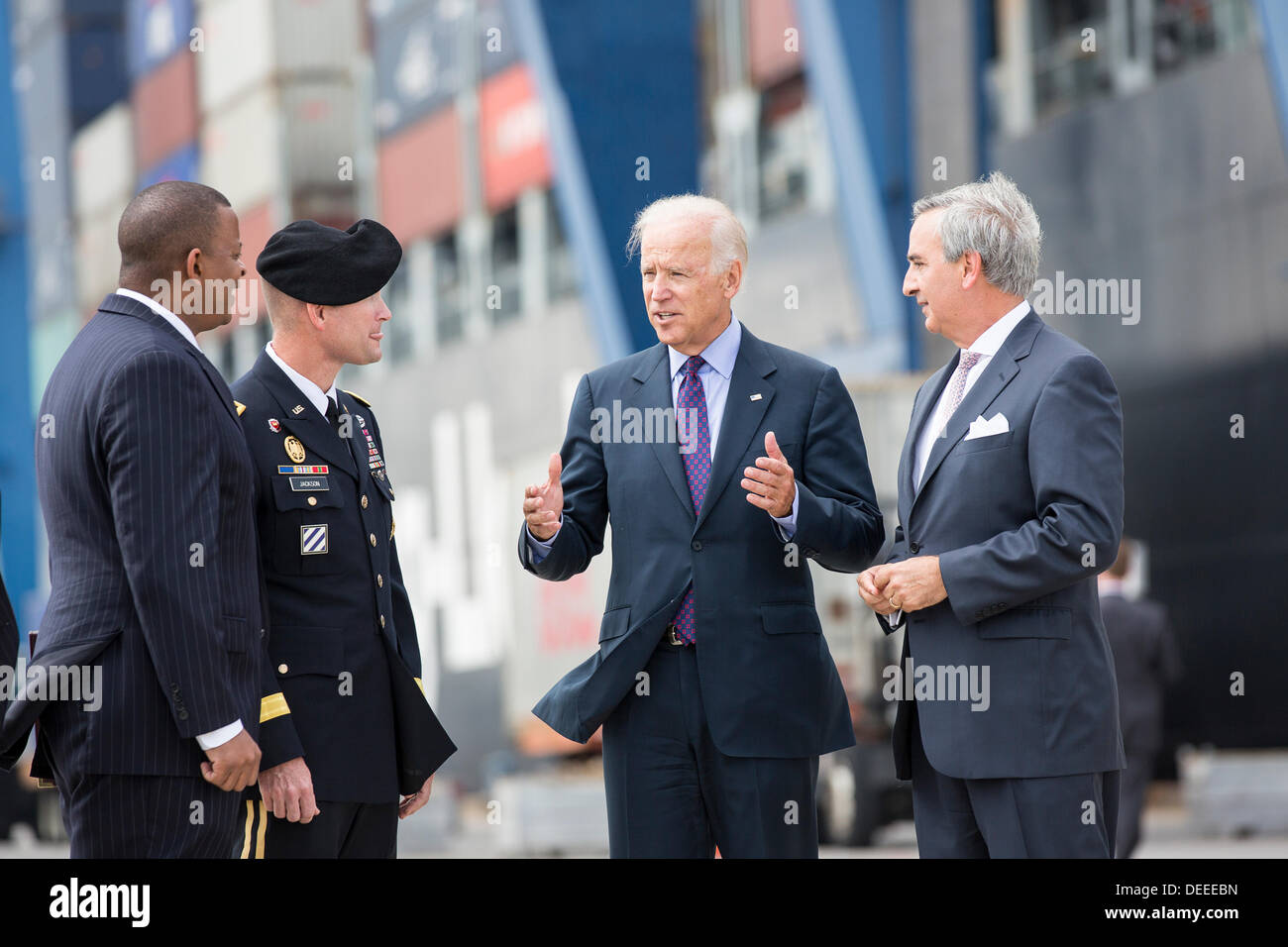 US Vice President Joe Biden talks with Charleston Ports Authority CEO Jim Newsome, right, General Jackson and Transportation Secretary Anthony Foxx during a visit to Wando Welch Terminal on September 16, 2013 in Charleston, South Carolina. Biden spoke about the need to improve America's transportation infrastructures for exports and economic growth. Stock Photo