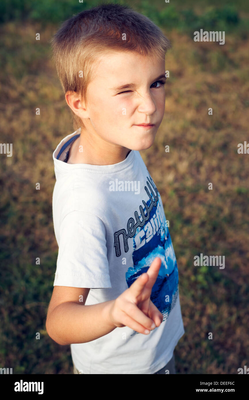 Portrait of boy (6-7) winking, France. Stock Photo