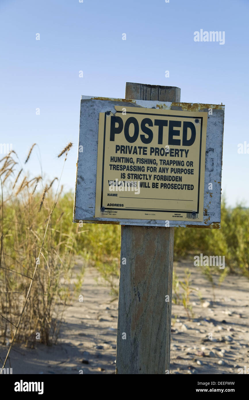 Posted private property, no trespassing sign on beachfront property, Lake Michigan shoreline, grasses growing in sand  Racine, Stock Photo