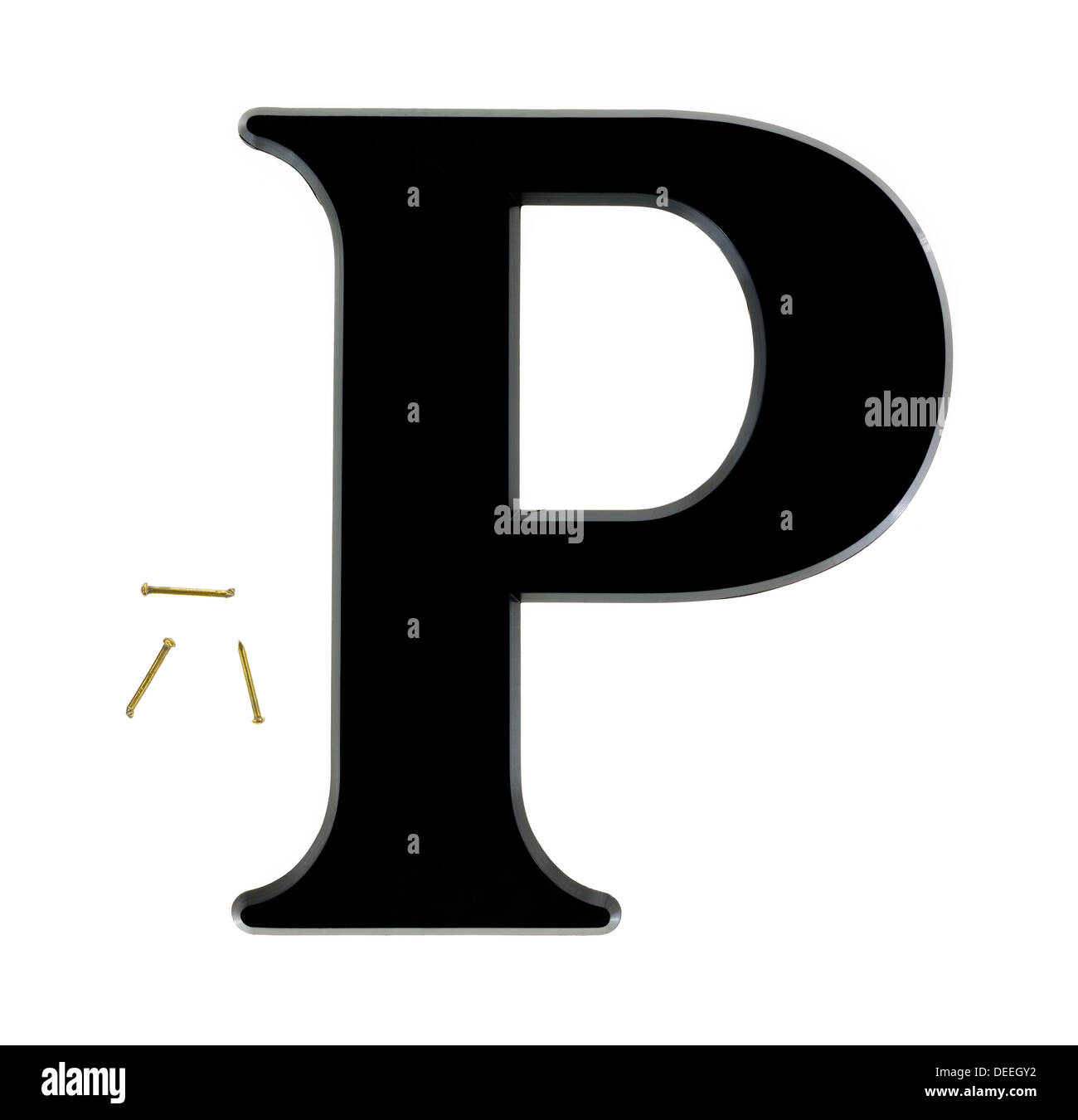 A large black house letter P with three small brass nails for mounting on a white background. Stock Photo