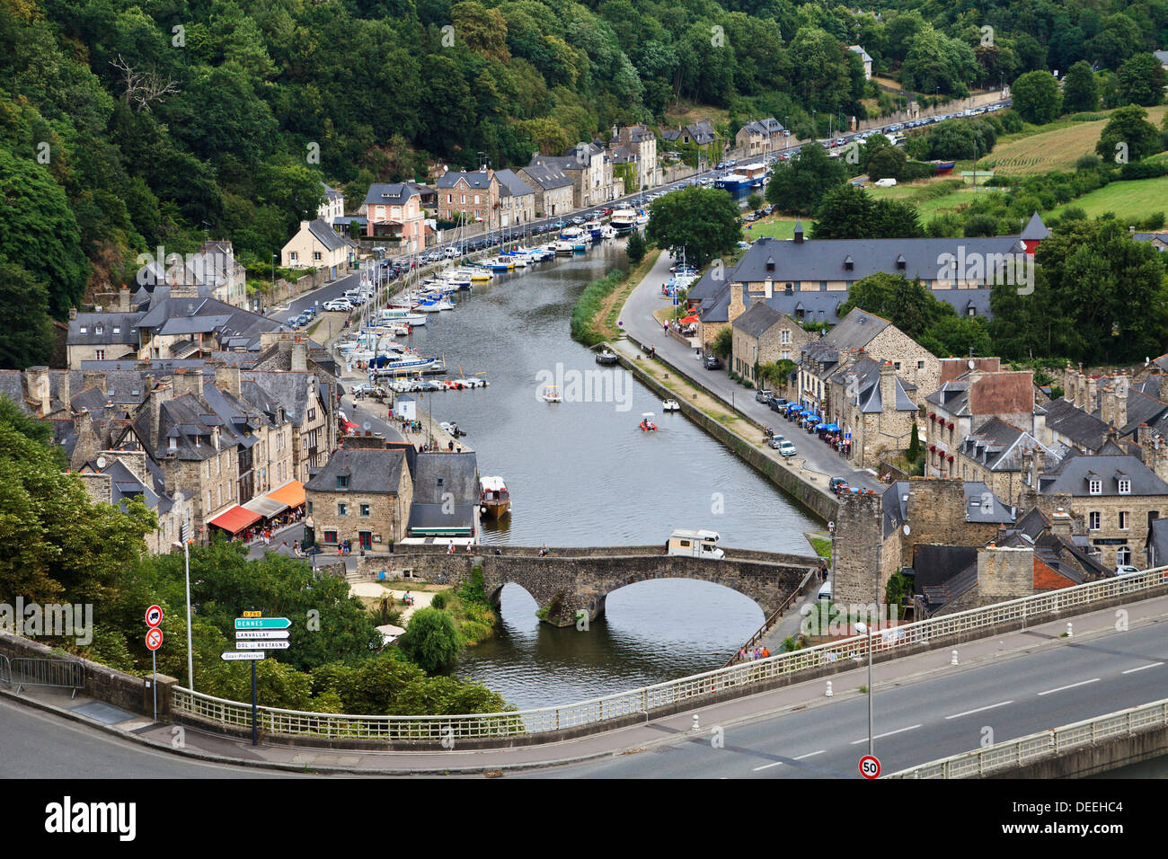 A motorhome crosses the old stone bridge across the River Rance at the Old Port, Dinan, Côtes-d'Armor, Brittany, France Stock Photo