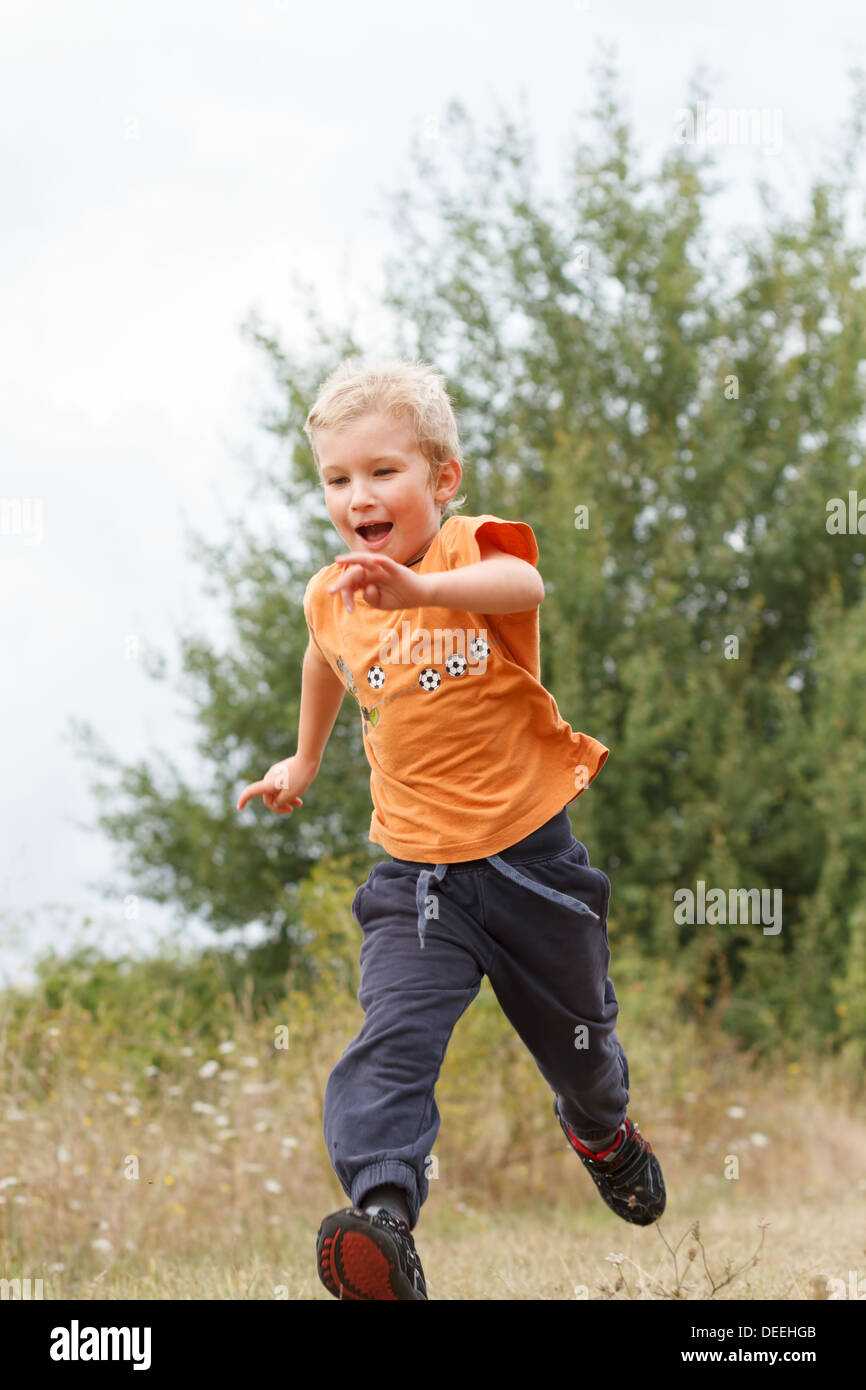 Boy (4-5) running, France. Stock Photo