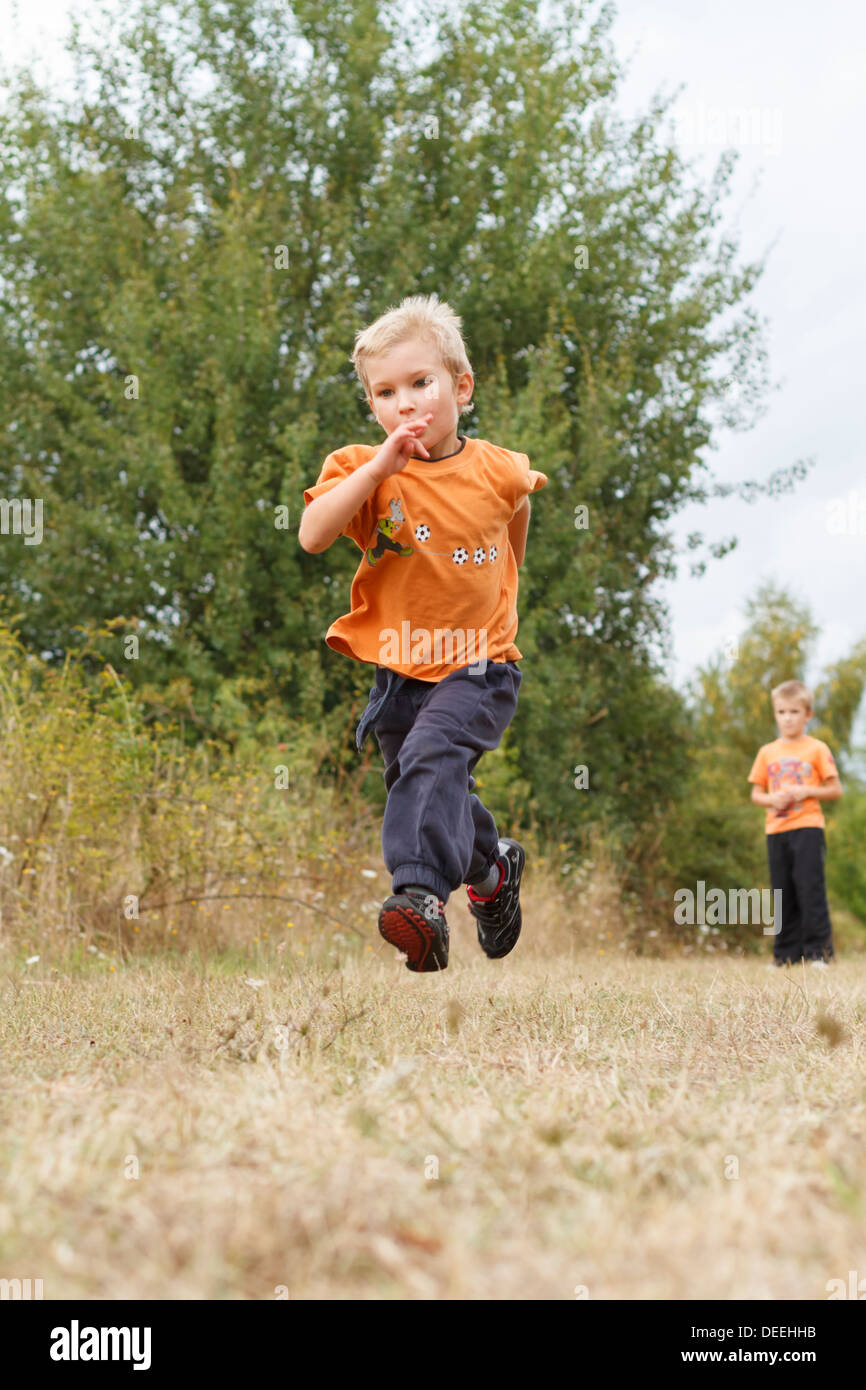 Boys (4-7) in meadow, France. Stock Photo