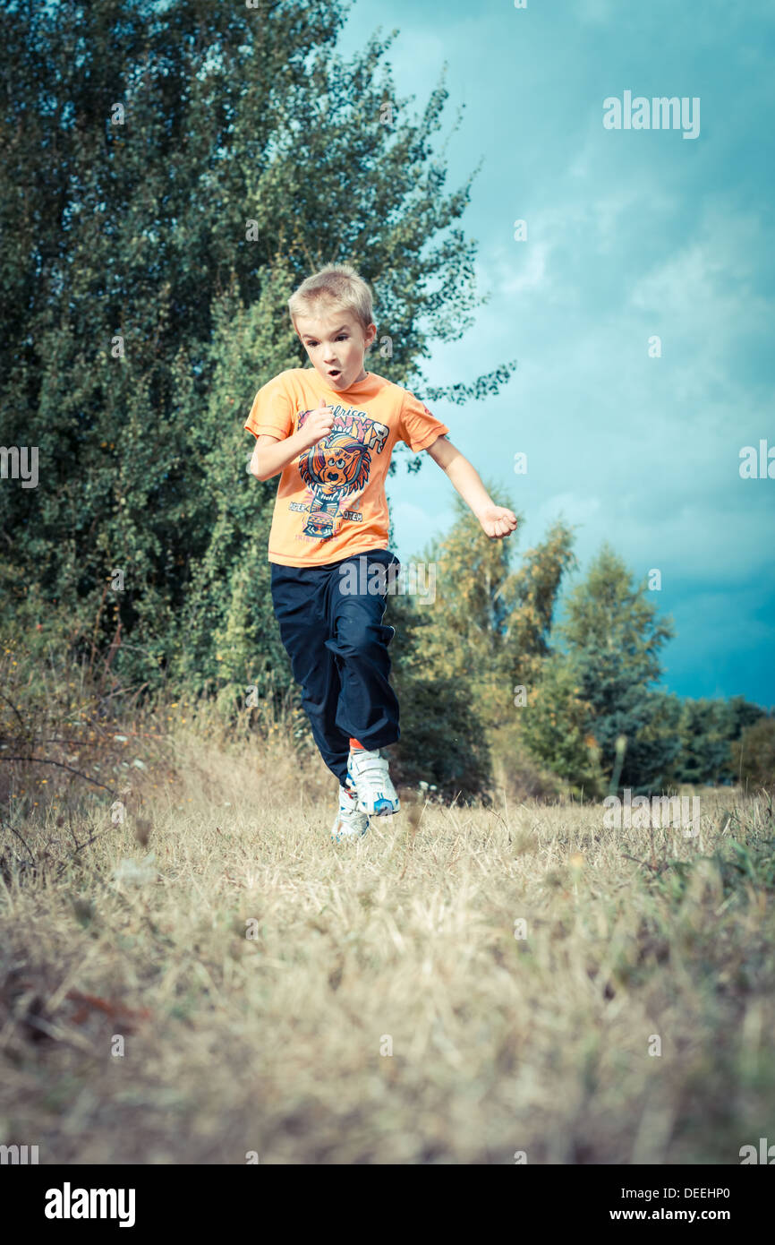 Boy (6-7) running on path. Stock Photo