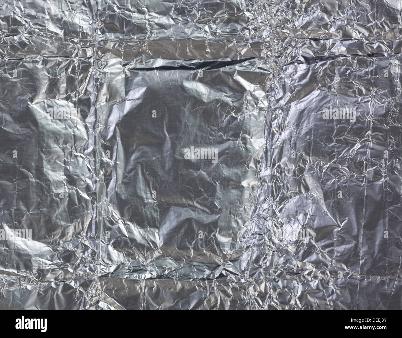 A very close view of used crinkled tin foil. Stock Photo