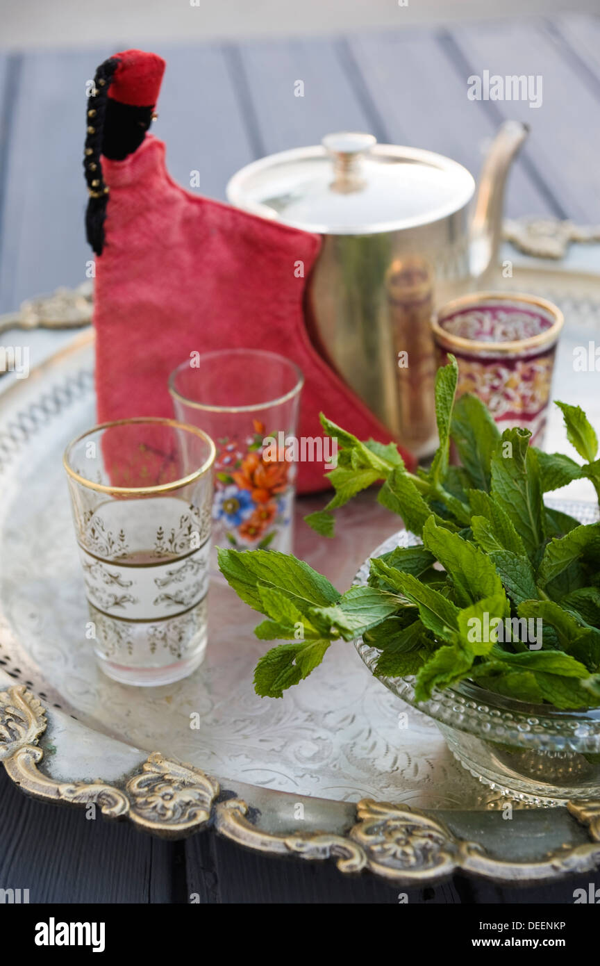 Mint leaves and tea glasses with teapot, Marrakesh Stock Photo