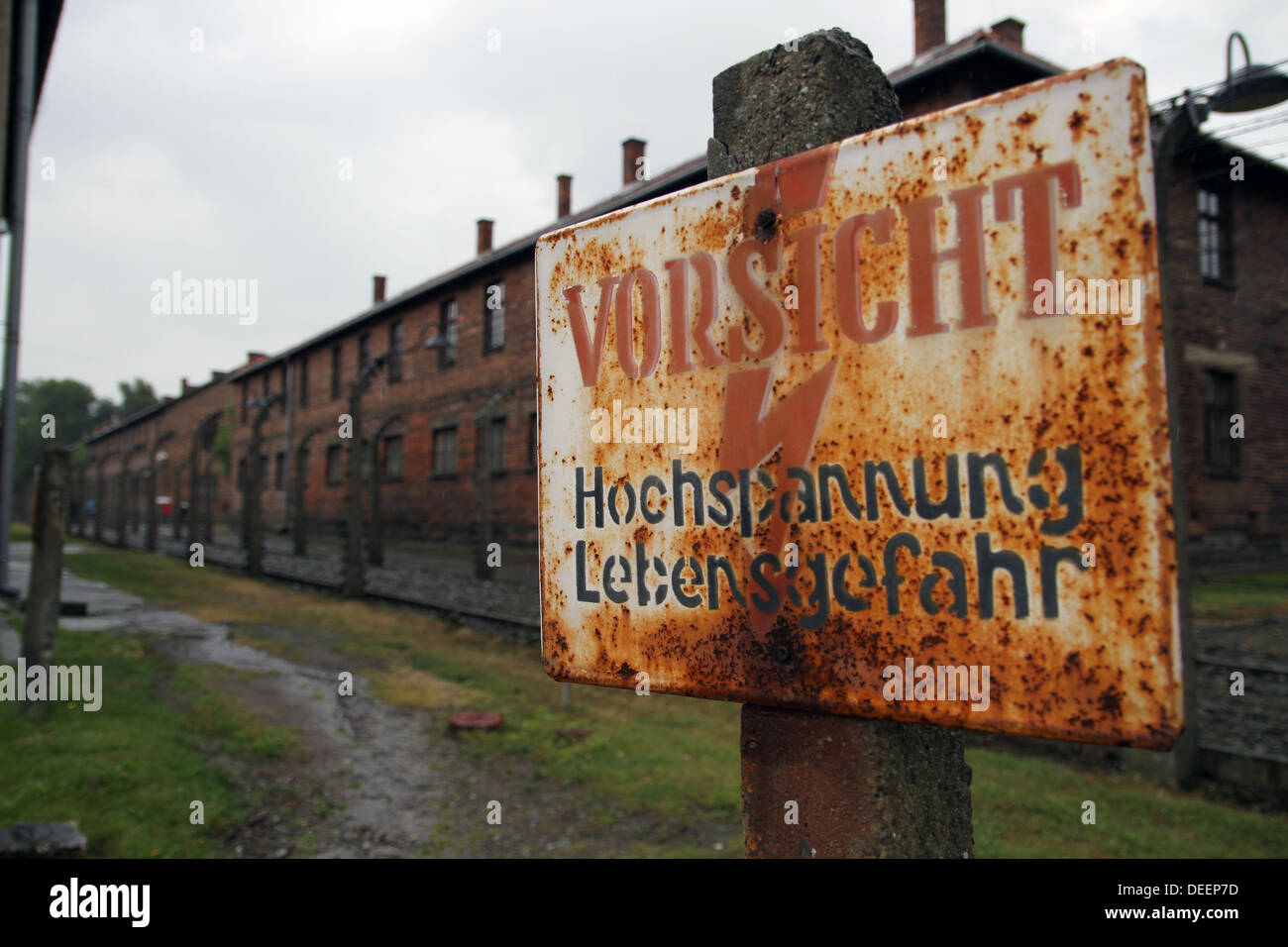 Sign 'vorsicht hochspannung lebensgefahr' is in front of some of the electrified perimeter fences. Stock Photo