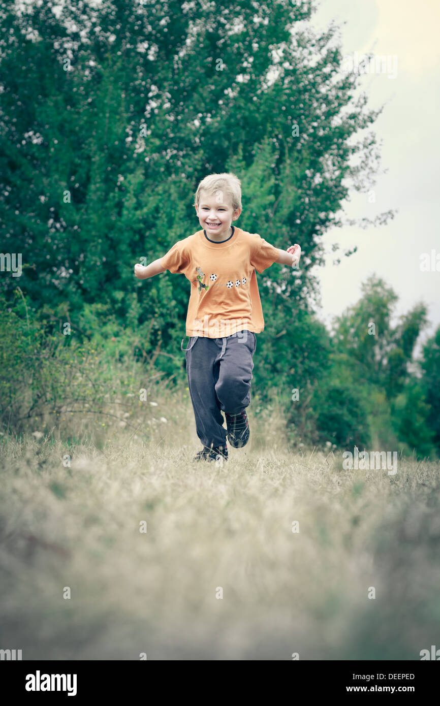 Boy (4-5) running on path. Stock Photo