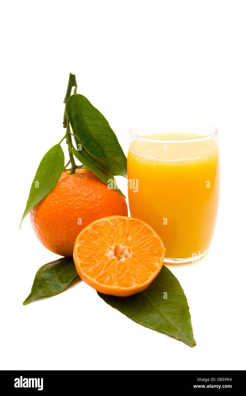 orange fruits with green leafs and fresh juice in glass isolated on a white backgroun Stock Photo