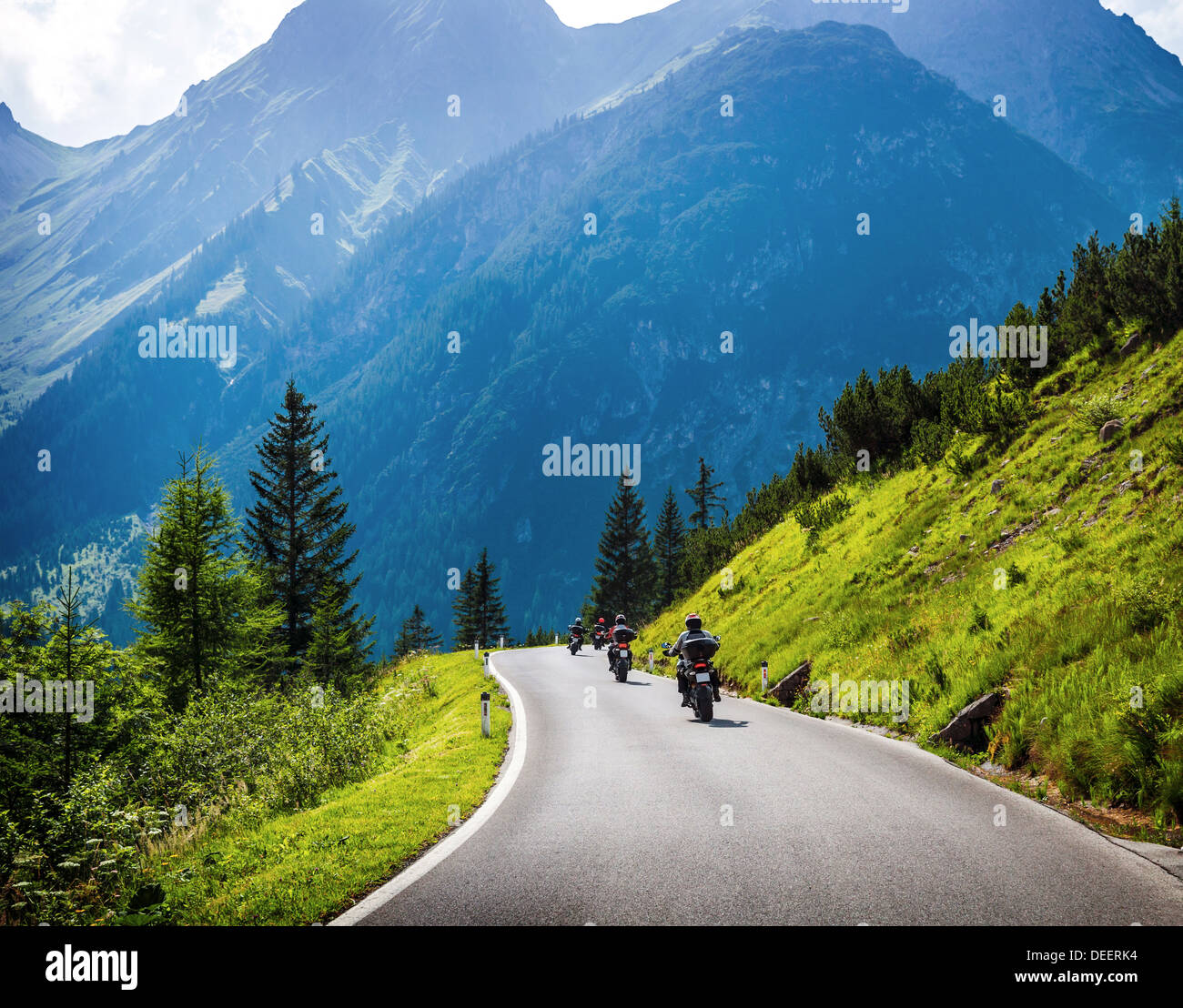 Moto racers riding on mountainous road, drive a motorcycle, summer adventure, extreme sport, travel to Europe, active lifestyle Stock Photo