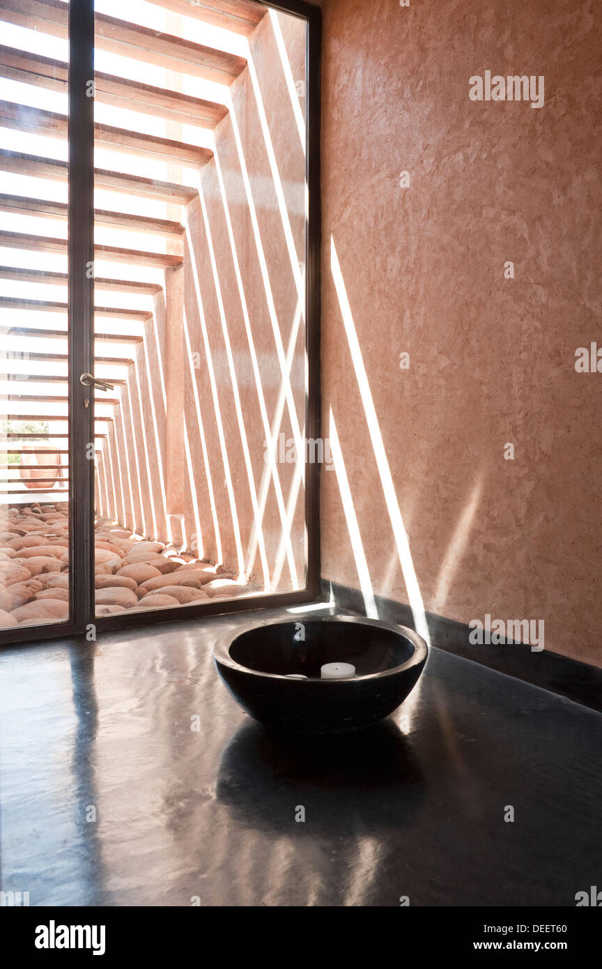 Candle in bow at glass door of Moroccan new-build with interior design Romain Michel-Meniere Stock Photo