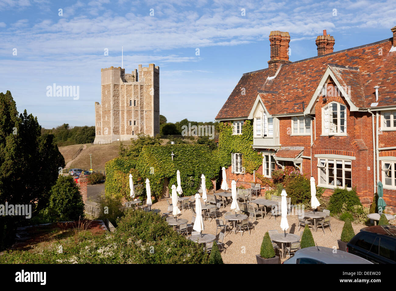 The Luxury Crown and Castle hotel with Orford castle in the background, Orford village, Suffolk UK Stock Photo