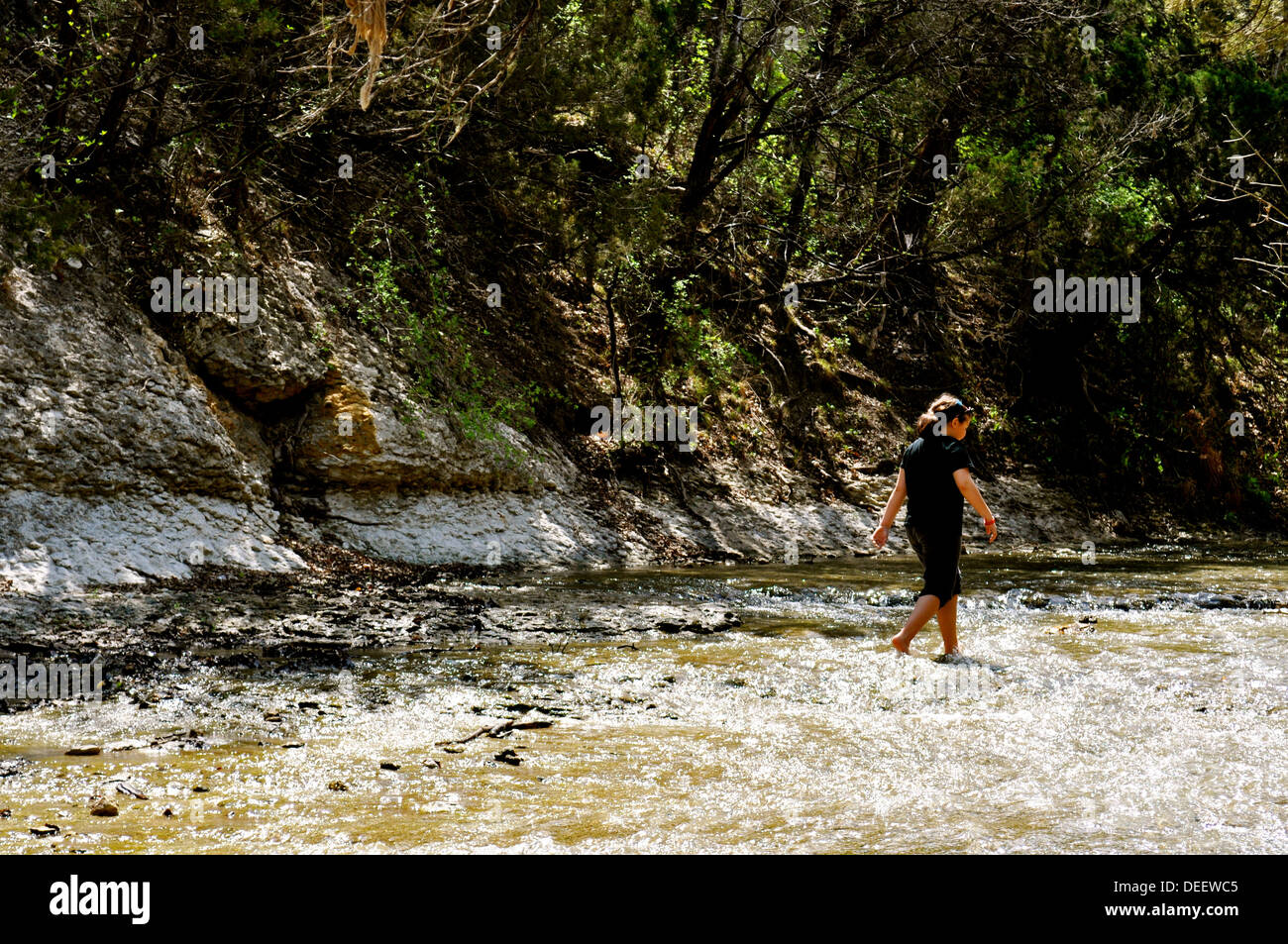 Girl walks in water Stock Photo - Alamy