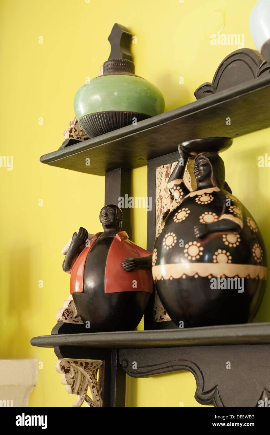 Wall mounted shelves with a collection of characterful African figures