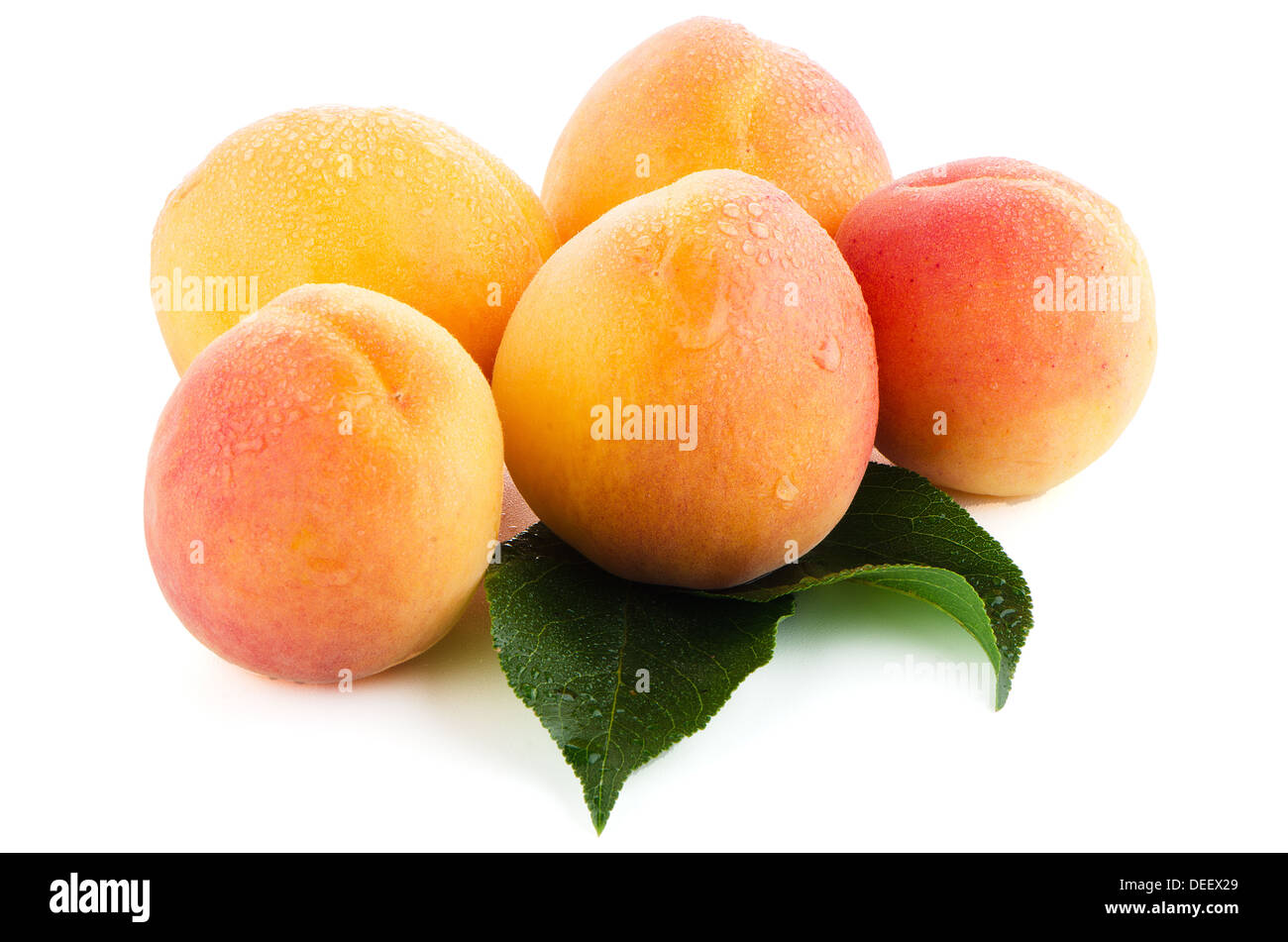 Sweet peaches with leafs on a white background Stock Photo
