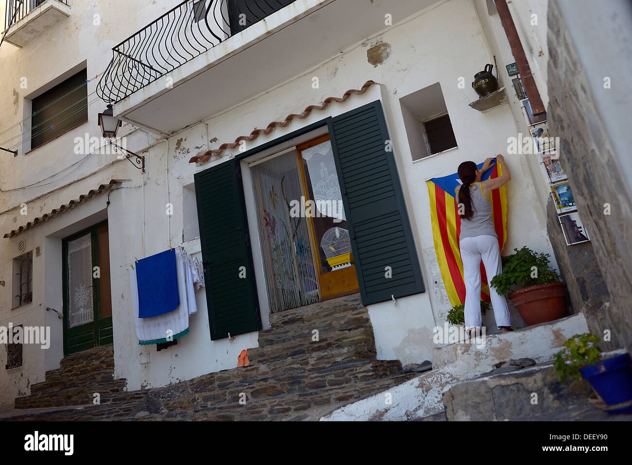 woman raises catalonian flag cadaques spain Stock Photo