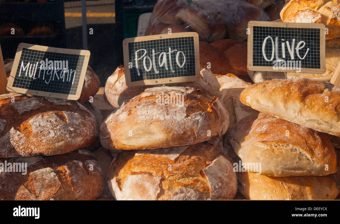 Local bakery merchant selling loaf of Potato bread at the Farmers
