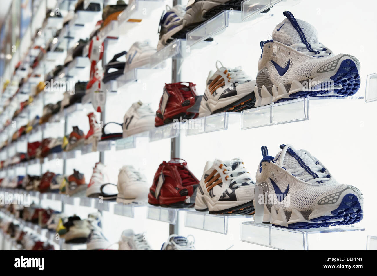 Sports shoes in shoe shop, shopping mall Stock Photo - Alamy