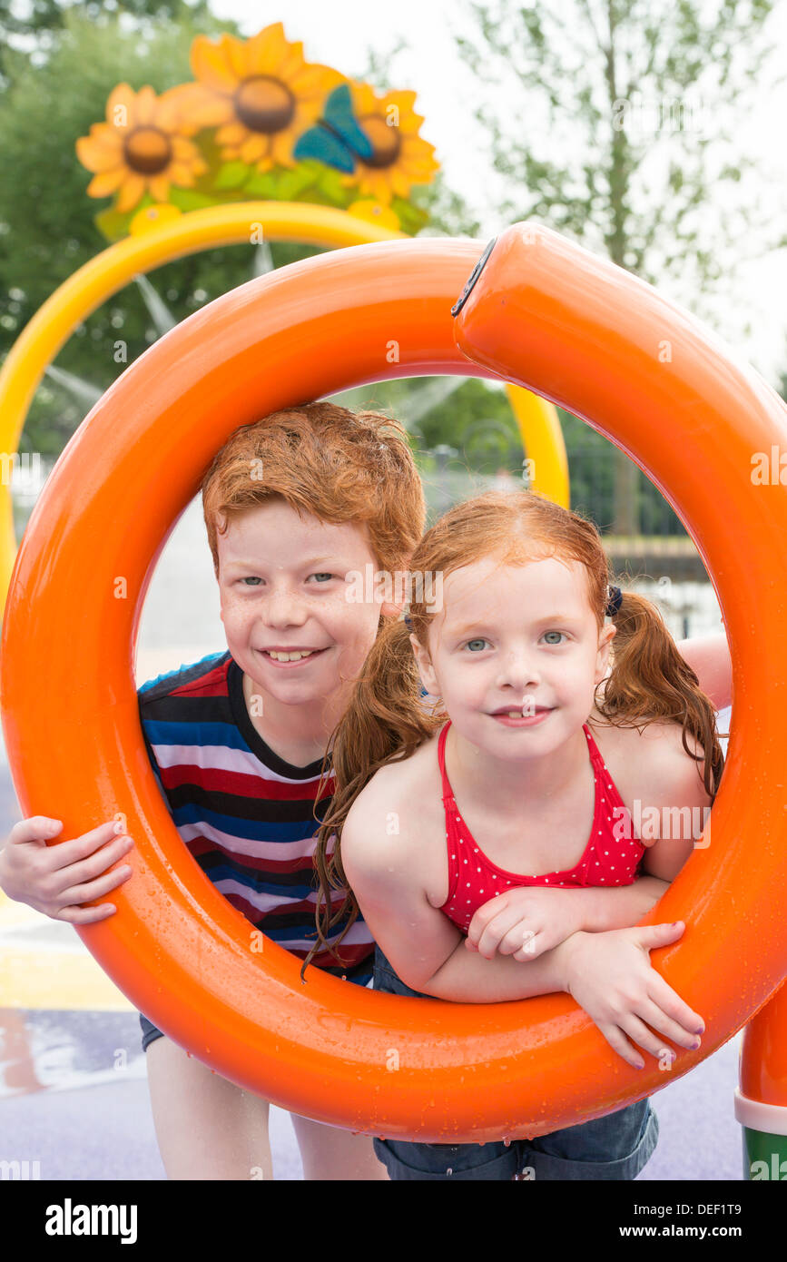 Children playing in a water play area Stock Photo