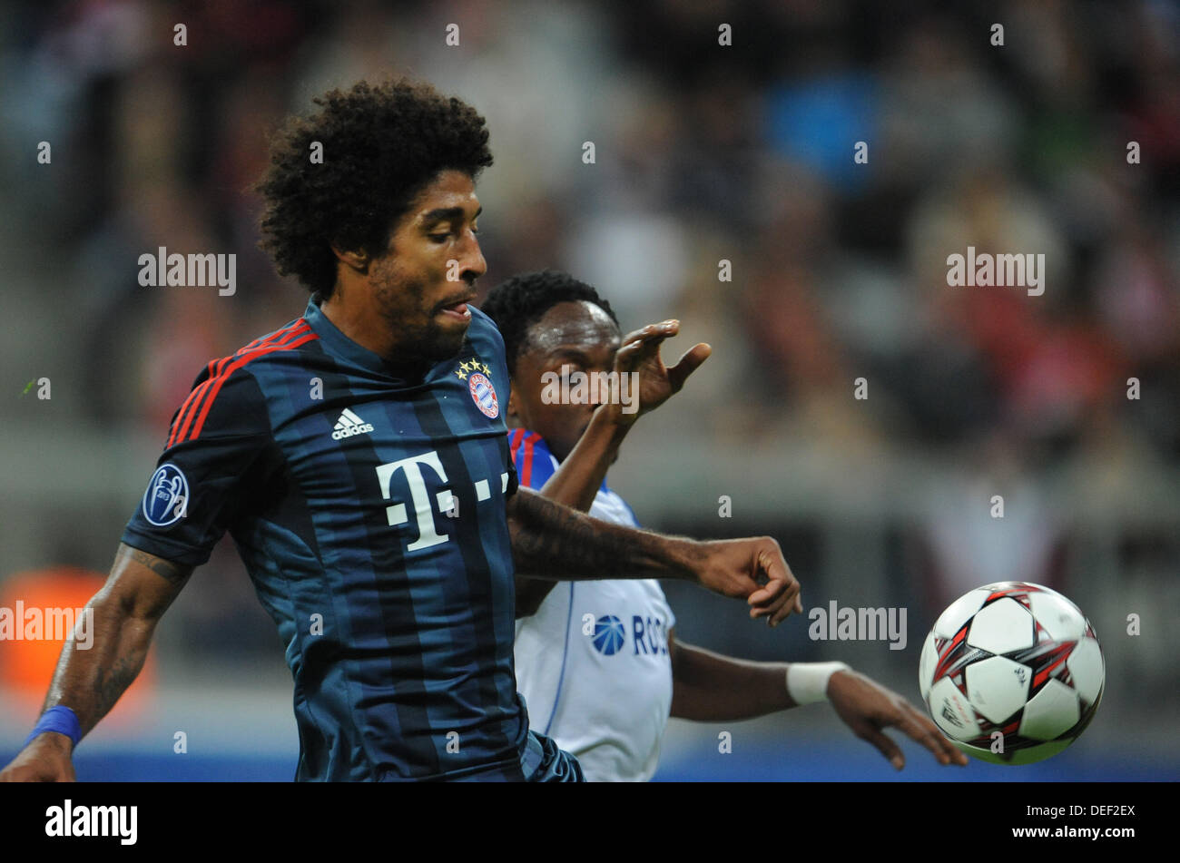 Munich, Germany. 17th Sep, 2013. Munich's Dante (L) and Moscow's Ahmed Musa vie for the ball during the UEFA Champions League Group D soccer match between FC Bayern Munich and CSKA Moscow at München Arena in Munich, Germany, 17 September 2013. Photo: Andreas Gebert/dpa/Alamy Live News Stock Photo