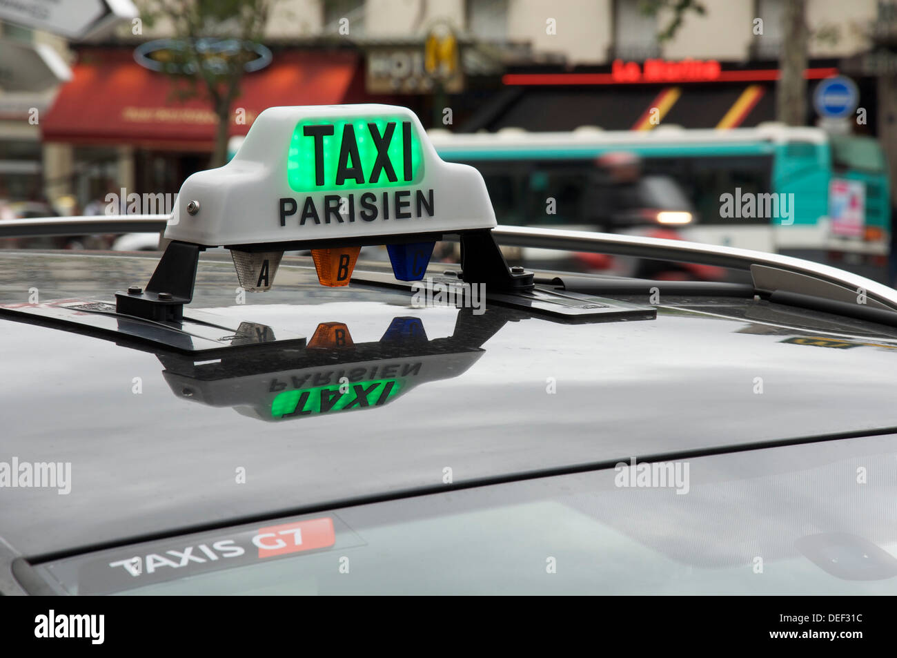 French public transport. The illuminated roof sign of a Parisian taxi cab, waiting for its next fare. Paris, France. Stock Photo