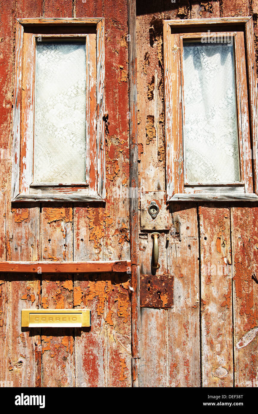 An old flaking red door in Portugal Stock Photo