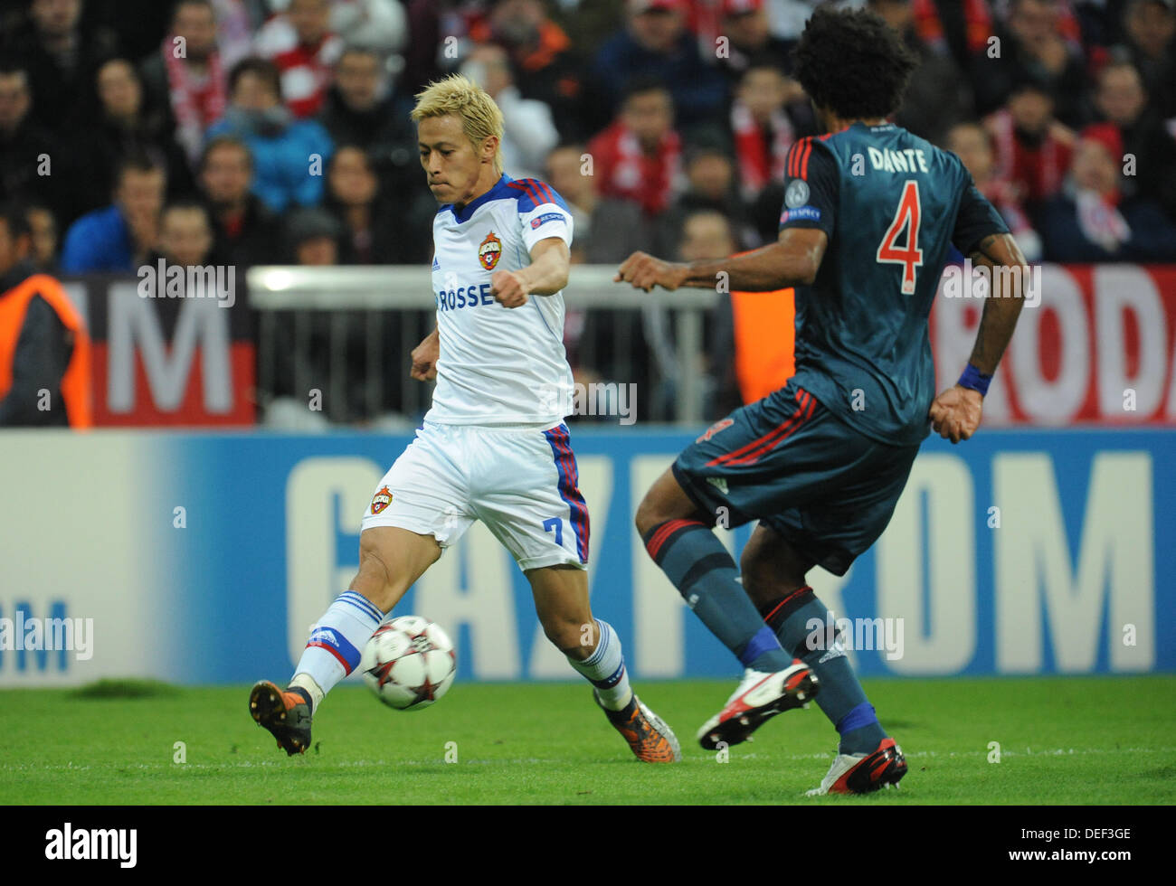 Munich's Dante (R) and Moscow's Keisuke Honda vie for the ball during the UEFA Champions League Group D soccer match between FC Bayern Munich and CSKA Moscow at München Arena in Munich, Germany, 17 September 2013. Photo: Andreas Gebert/dpa Stock Photo
