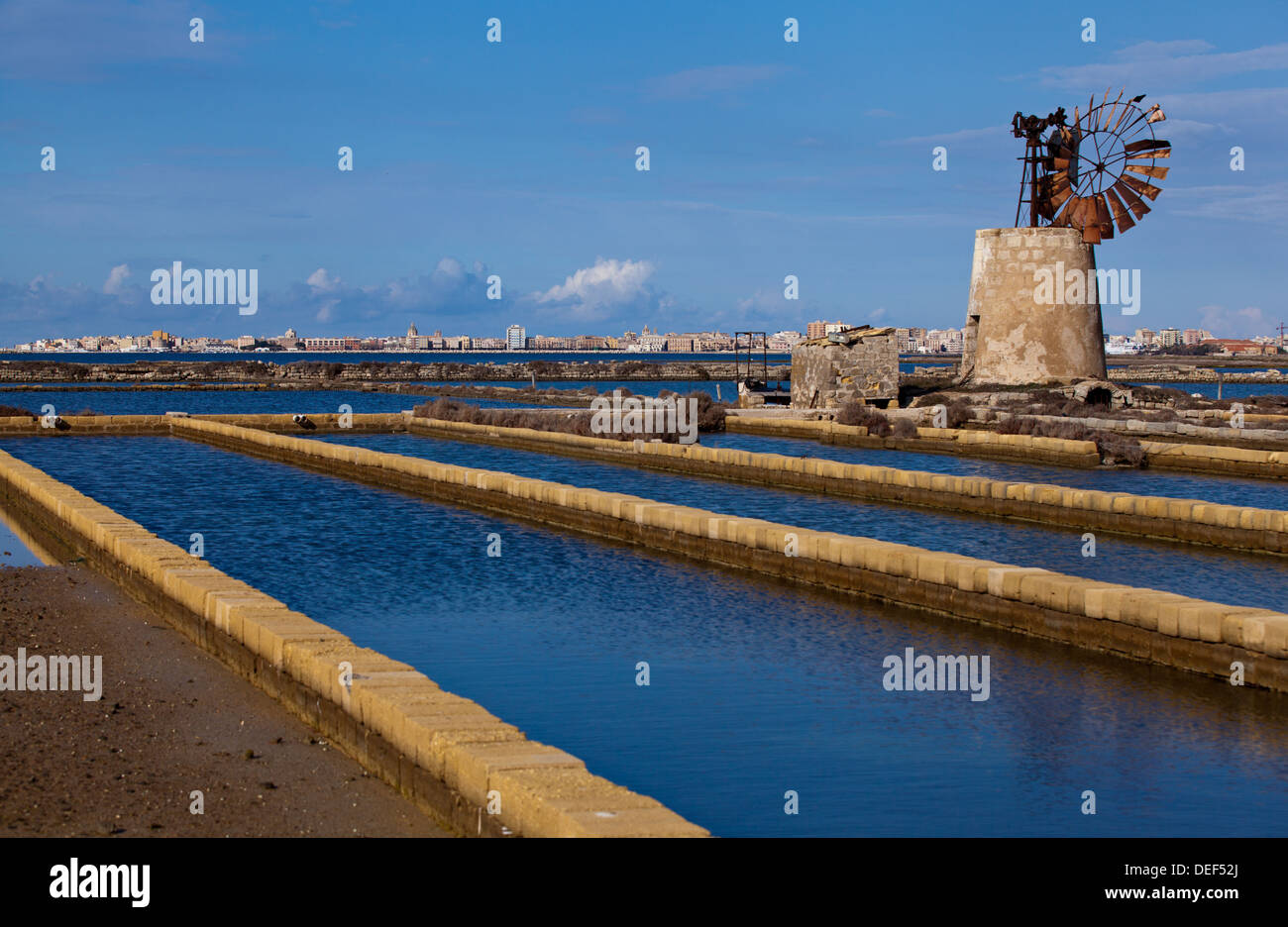 Windmill of Trapani Salt Pans in Trapani in the Province of Trapani, Sicily. Stock Photo