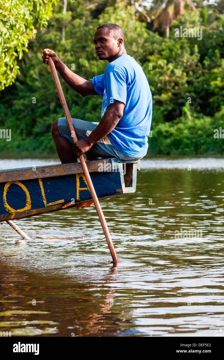 Africa, Cameroon, Kribi. Man rowing traditional pirogue boat down Lobe River Stock Photo Alamy