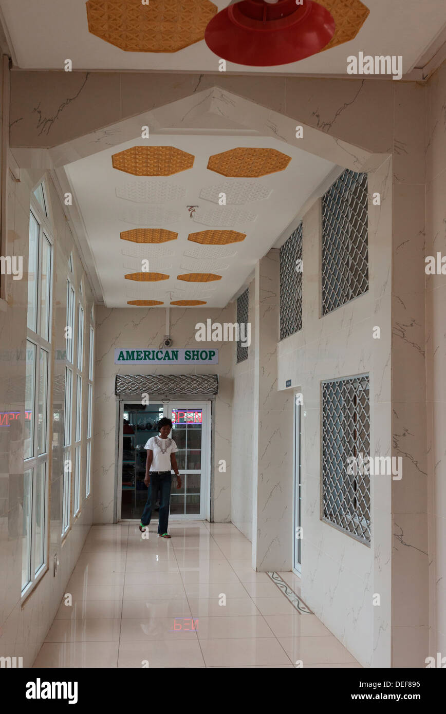Africa, Cameroon, Limbe. Woman exiting the American Shop Stock Photo
