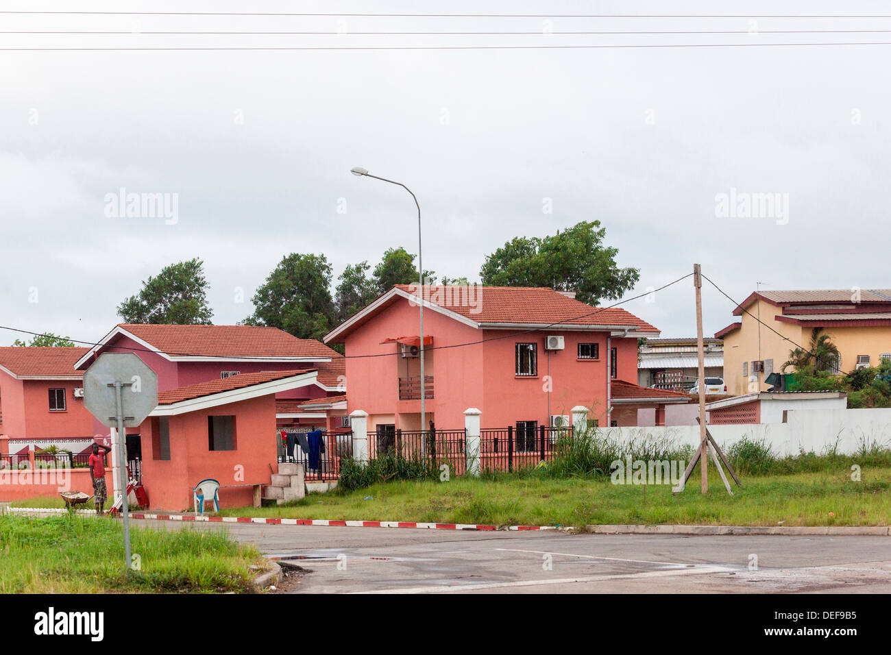Africa, Gabon, Libreville. Man working on house Stock Photo Alamy