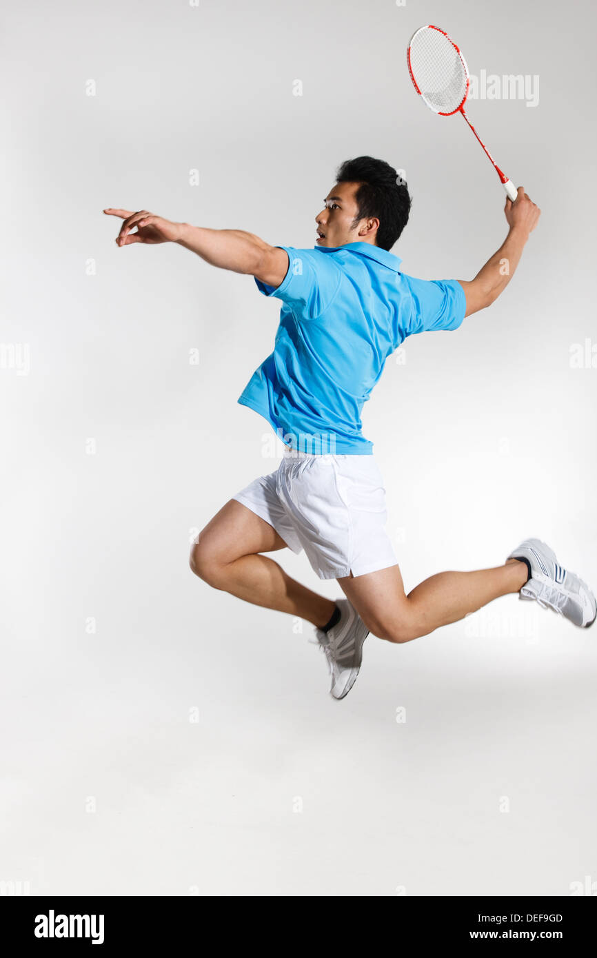 Young man playing badminton Stock Photo - Alamy