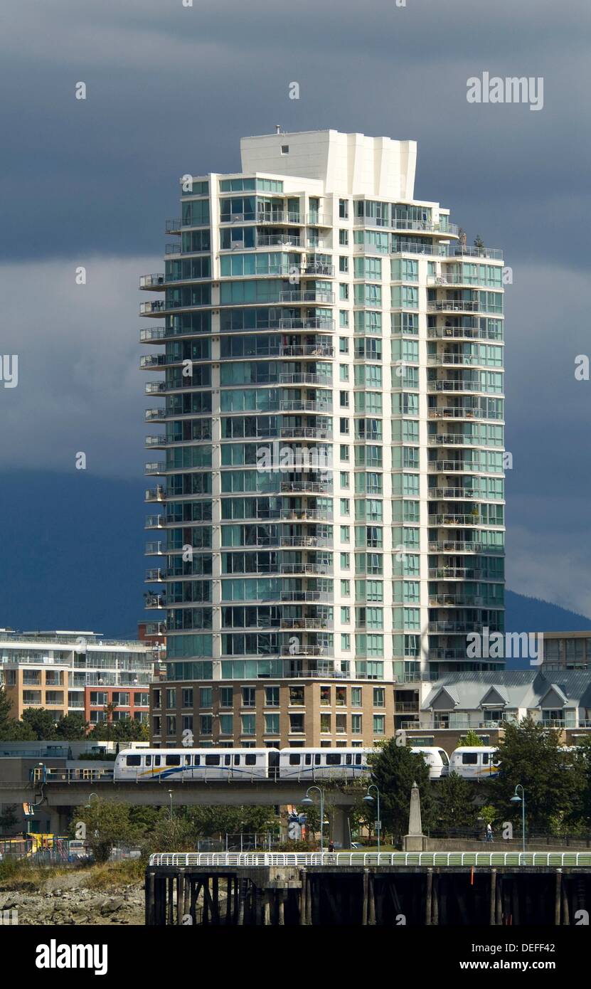 The Skytrain passes below an apartment tower at the east end of False