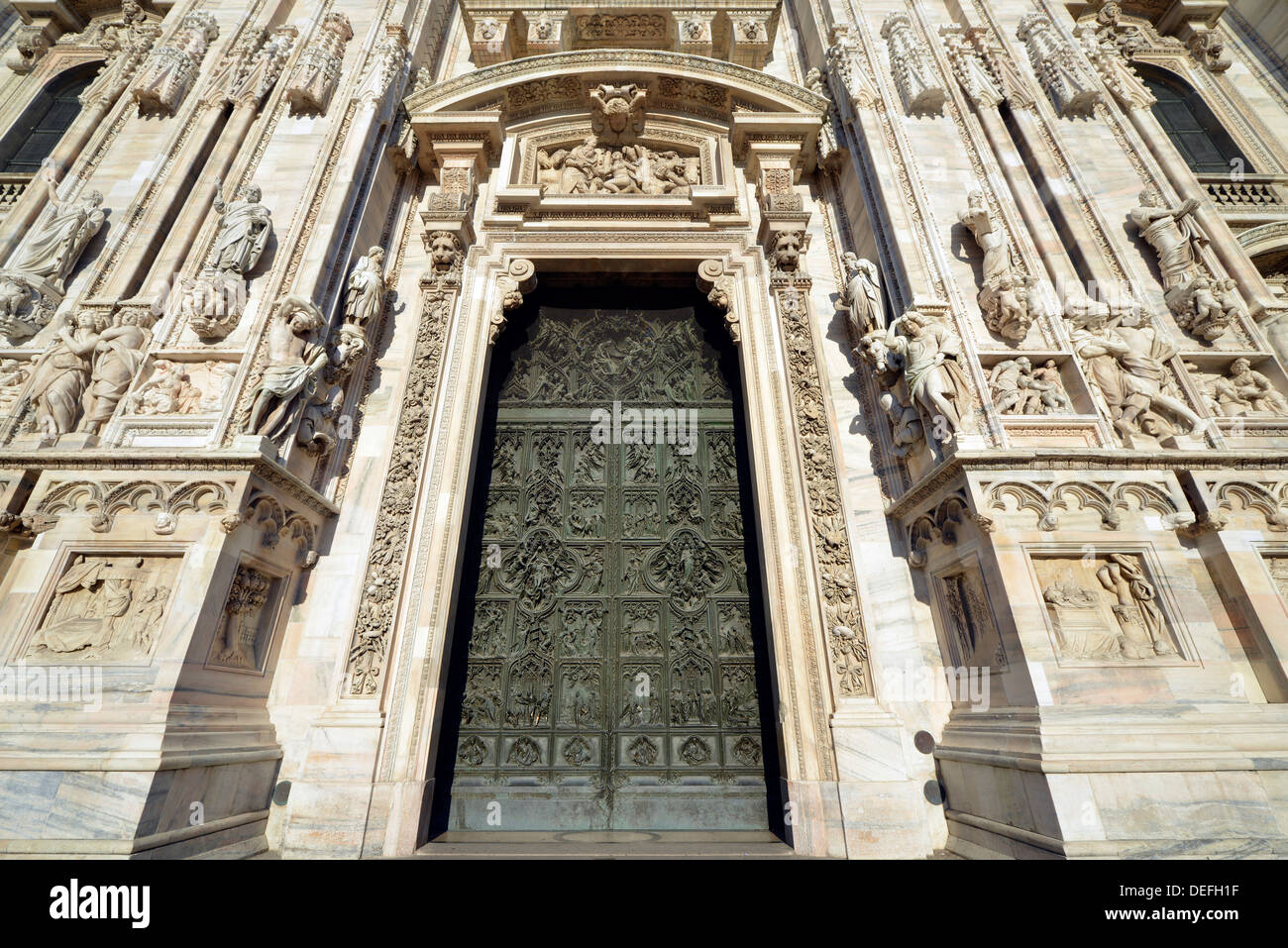 Bronze main door with scenes from the life of Mary, sculptor Lodovico Pogliaghi, west facade of Milan Cathedral or Duomo di Stock Photo