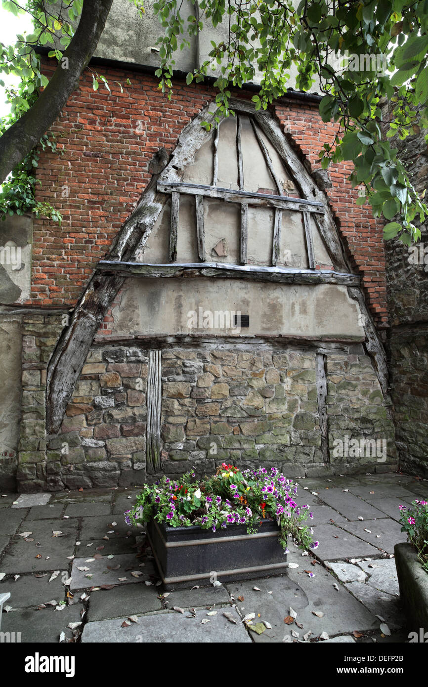 A wooden cruck remaining from the demolition of an old medieval building, High Street, Wirksworth, Derbyshire. Stock Photo