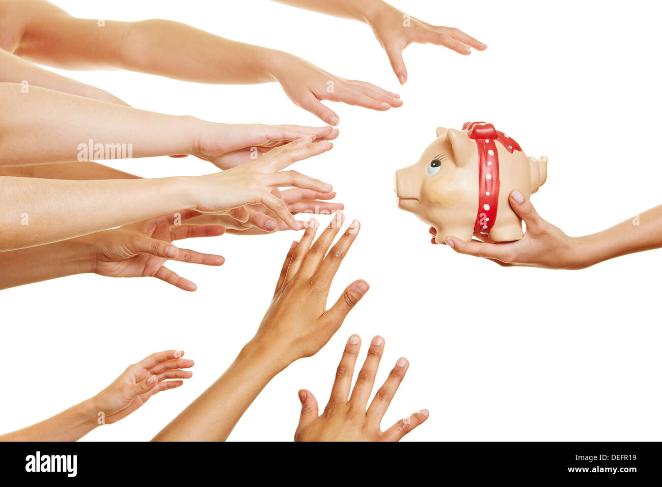 Many hands reaching for money in a piggy bank in a hand Stock Photo