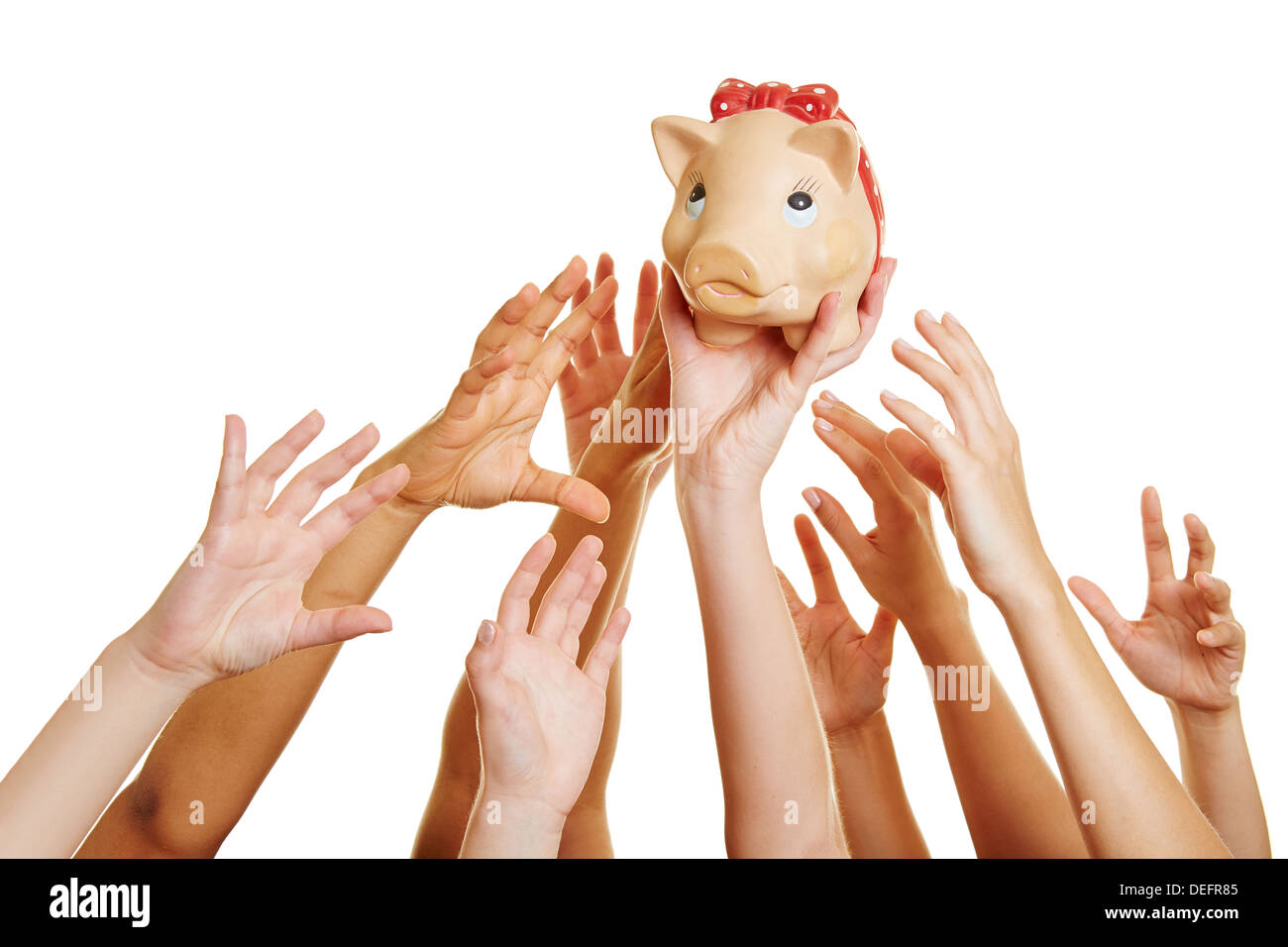 Many desperate hands reaching for money in a piggy bank Stock Photo