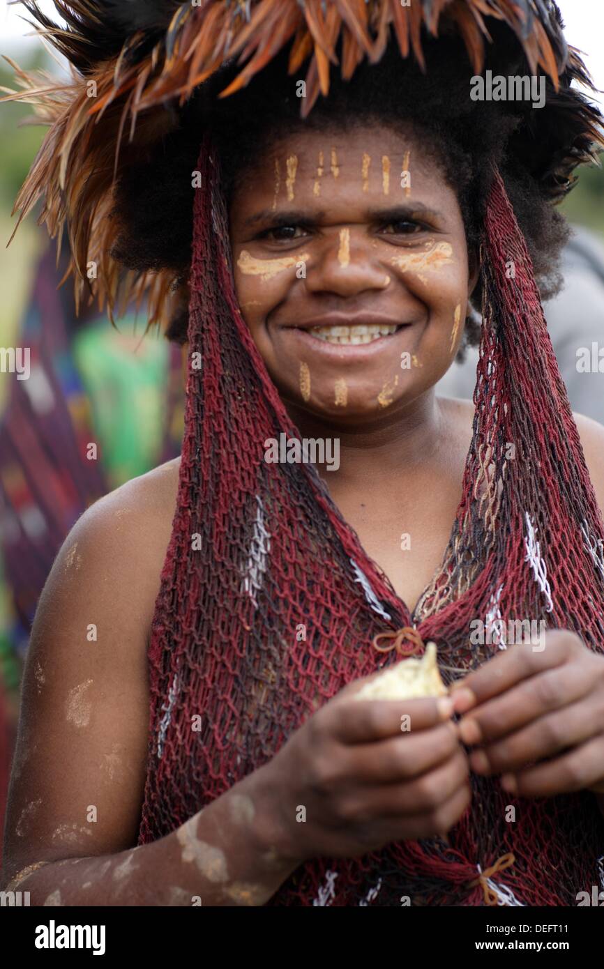 Portrait of local Papuan girl, looking at the camera with traditional ...