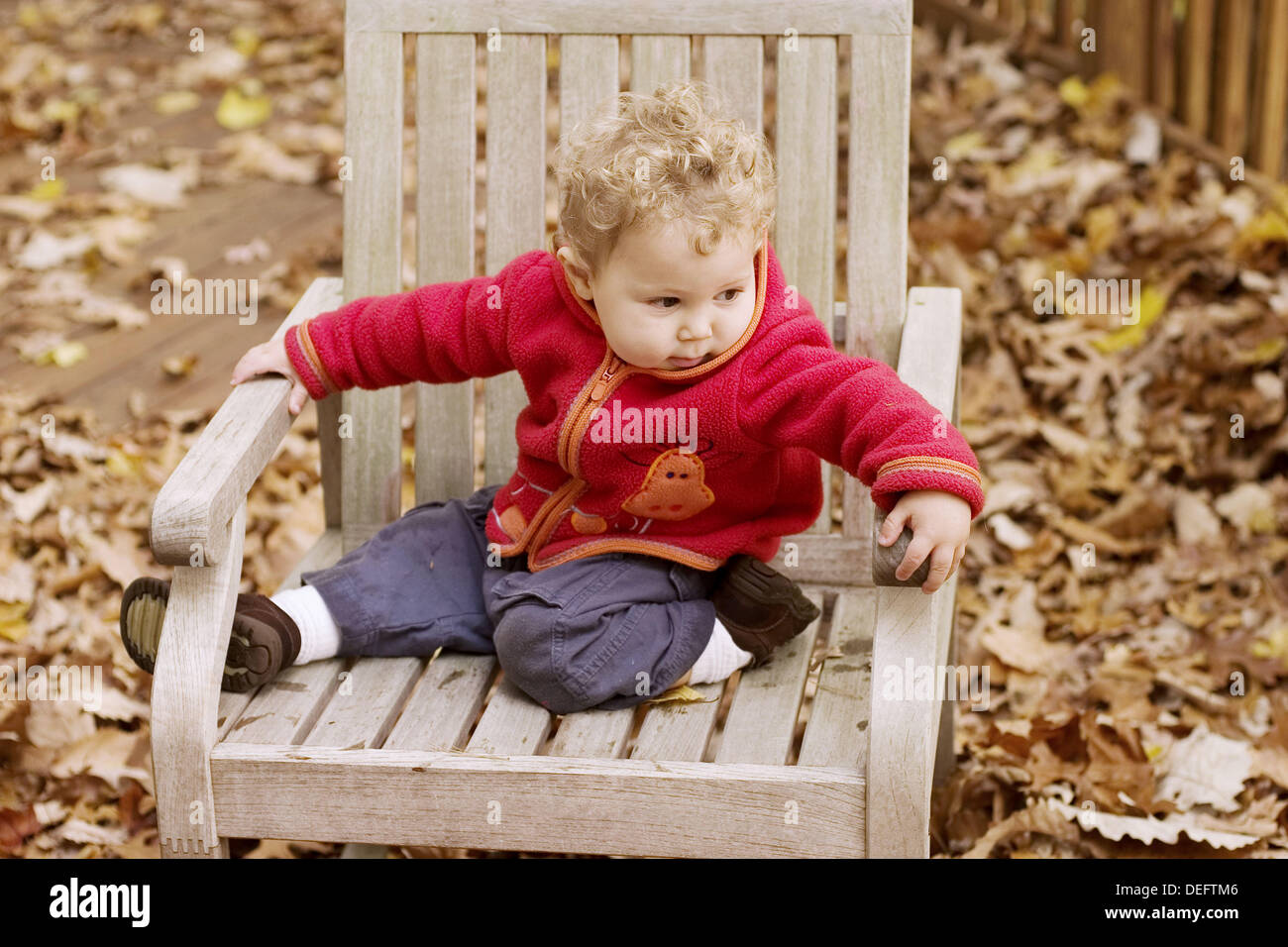One year old boy sitting on a deck chair Stock Photo Alamy