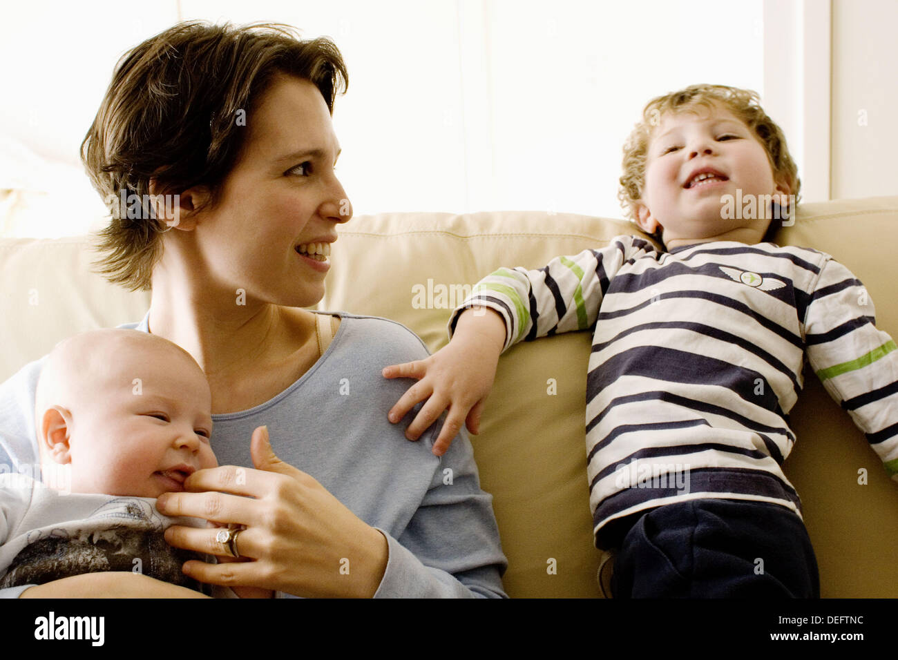 Newborn baby leaning on mother hires stock photography and images Alamy
