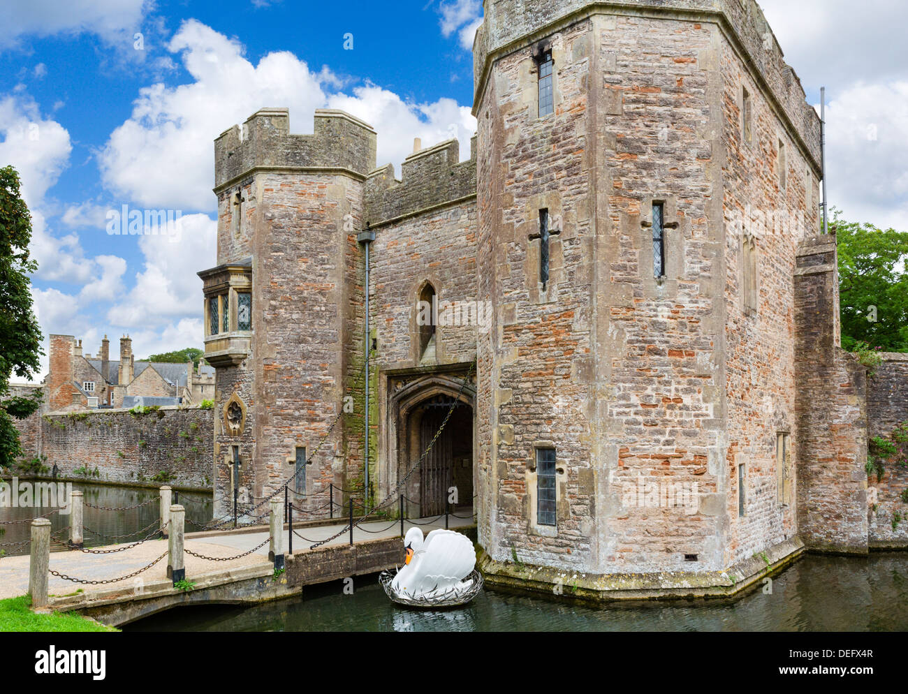 Gateway to the Bishop's Palace with swan sculpture in the moat, Wells, Somerset, England, UK Stock Photo