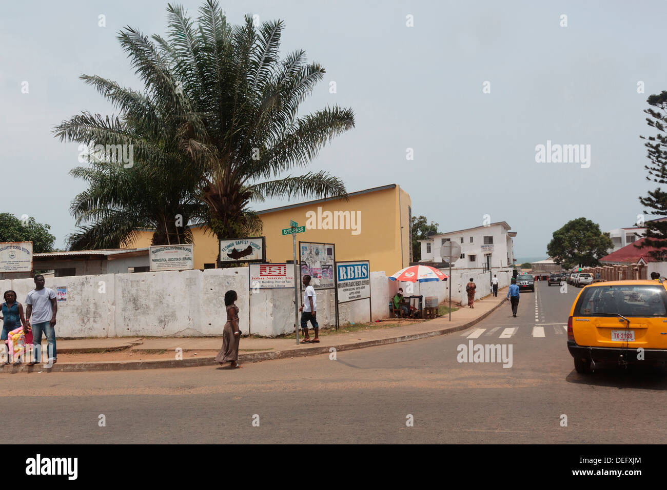 Africa, Liberia, Monrovia. People walking down street. Stock Photo