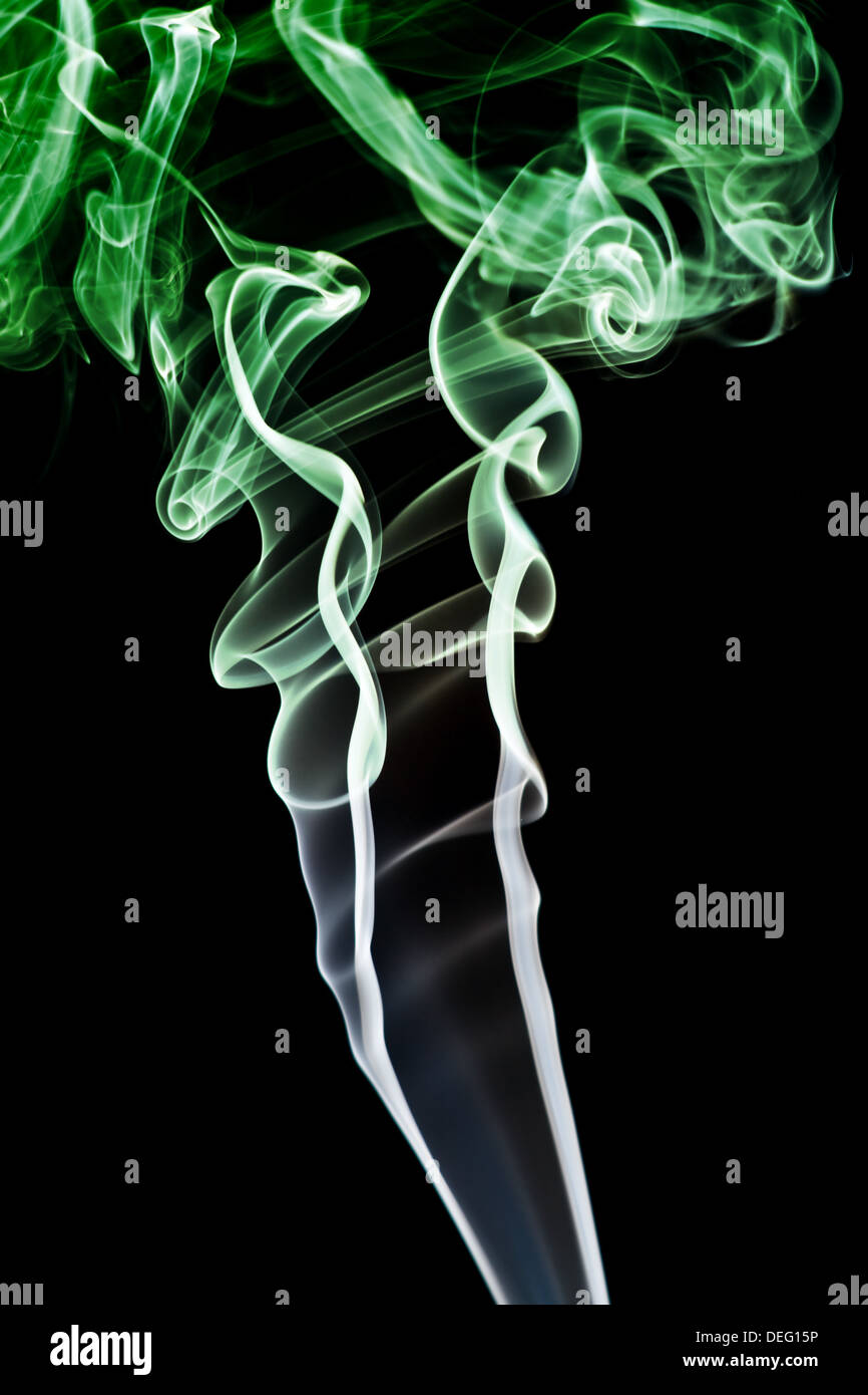Abstract green smoke. Isolated on a black background Stock Photo - Alamy